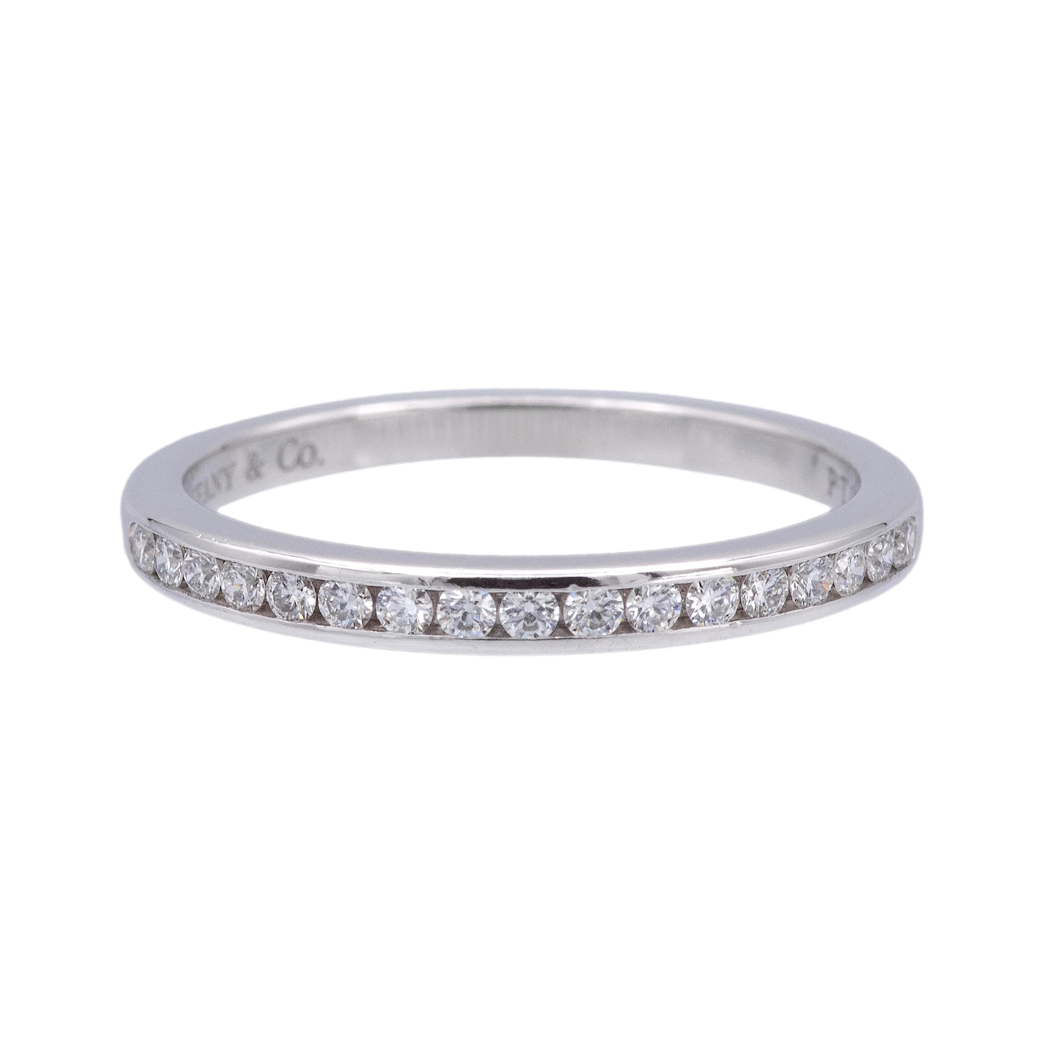Tiffany & Co. half-circle wedding band ring from the Tiffany setting collection finely crafted in platinum featuring 17 round brilliant cut diamonds weighing 0.17 carats ranging D-G color, IF- VS2 clarity, measuring at 2 mm wide, Can be worn on its