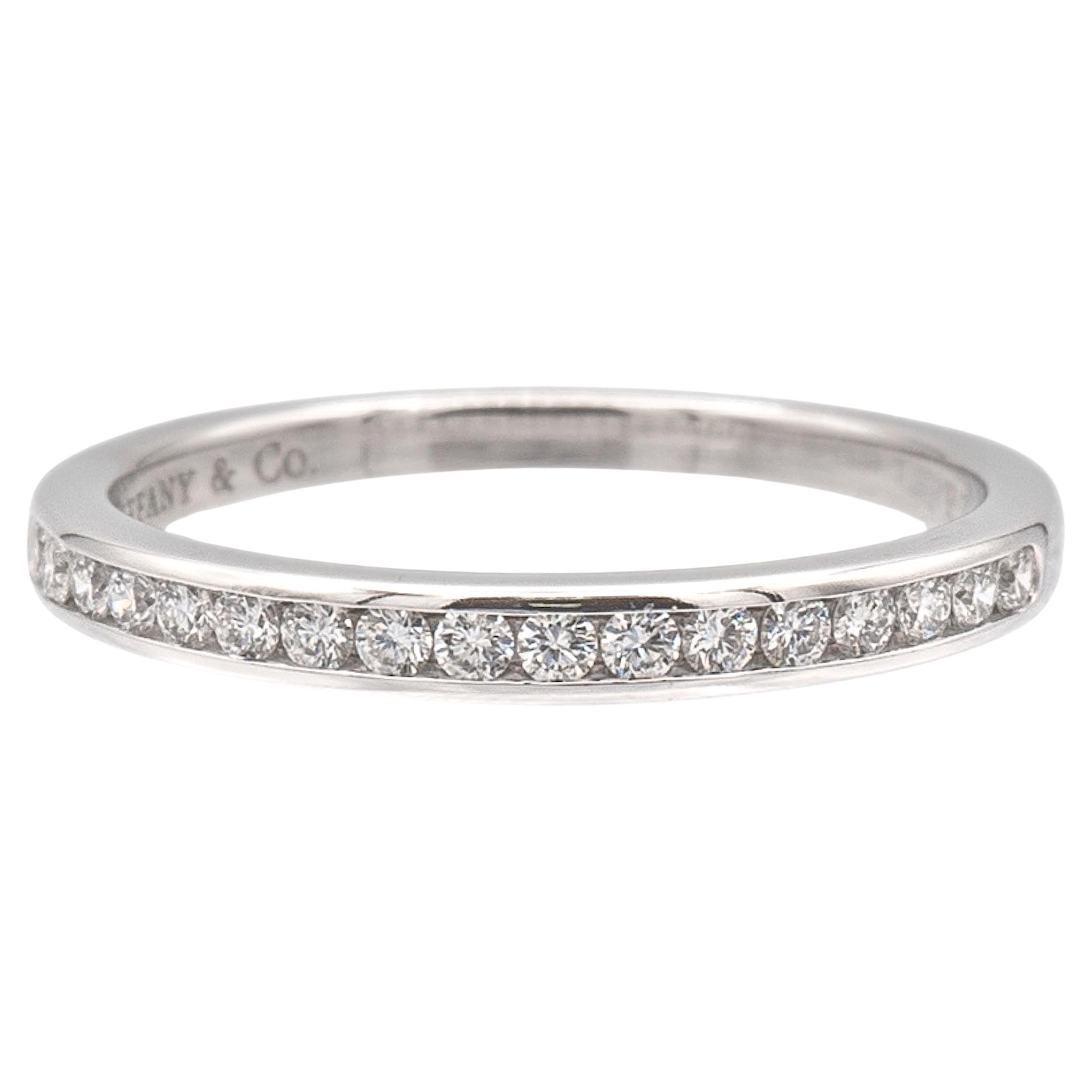 Tiffany & Co. half-circle wedding band ring from the Tiffany setting collection finely crafted in platinum featuring 15 round brilliant cut diamonds weighing 0.24 carats ranging D-G color, IF- VS2 clarity, measuring at 2 mm wide, Can be worn on its