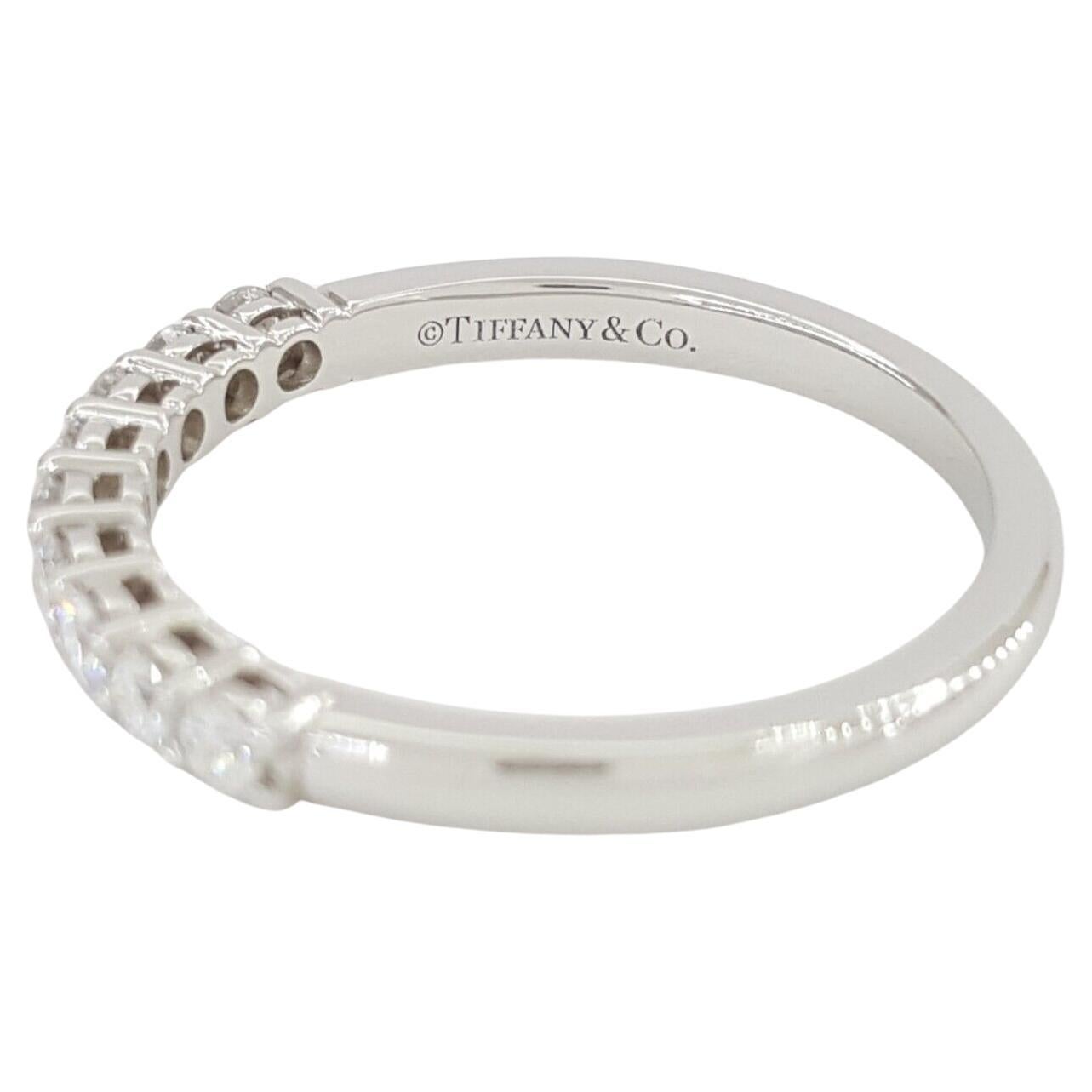 Tiffany & Co Forever Platinum Half Circle Wedding/Anniversary Band/Ring, adorned with a total weight of 0.27 ct Round Brilliant Cut Diamonds.

Crafted with precision and authenticity, this exquisite ring weighs 2.6 grams and is sized at 6.25, with
