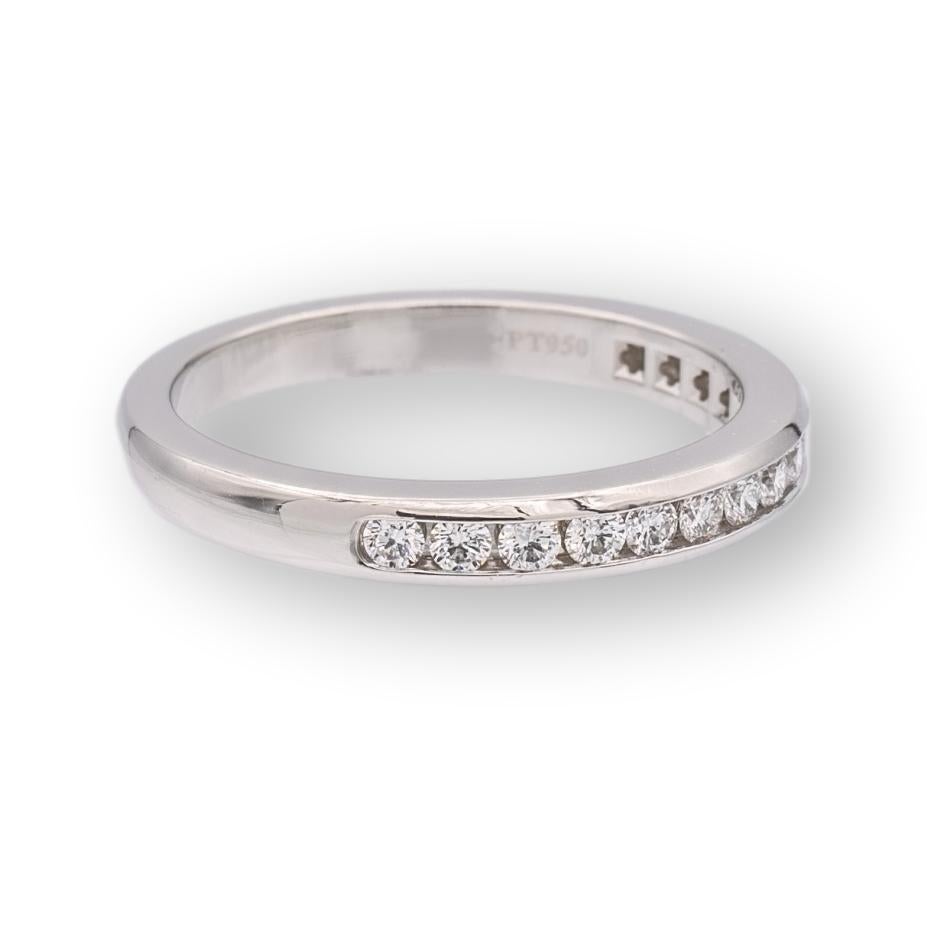 Tiffany & Co. wedding/anniversary band finely crafted in platinum with 15 channel set round brilliant cut diamonds weighing 0.24 carats total weight ranging D-G color and IF (Internally Flawless)- VS2 clarity. Accompanied by Tiffany appraisal. 

