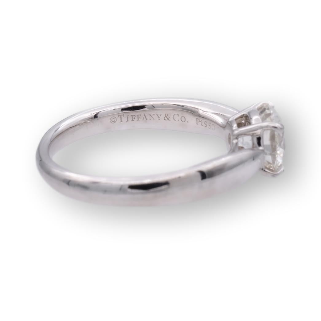 Tiffany & Co. engagement ring from the Harmony collection finally crafted in platinum featuring a round brilliant cut center diamond weighing 0.80 carats H color VS1 clarity. This ring has a tapered shank design. Ring is fully hallmarked with