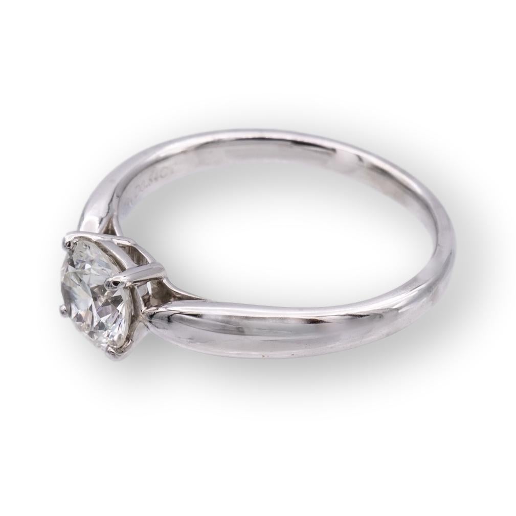 Tiffany & Co. engagement ring from the Harmony collection finally crafted in platinum featuring a round brilliant cut center diamond weighing 0.84 carats I color VVS1 clarity. This ring has a tapered shank design. Ring is fully hallmarked with
