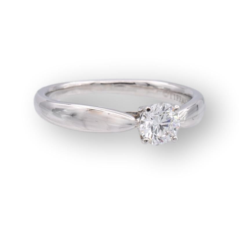 Tiffany & Co. engagement ring from the Harmony collection finally crafted in platinum featuring a round brilliant cut center diamond weighing 0.36 carats H color VS2 clarity. This ring has a tapered shank design. The original certificate for this