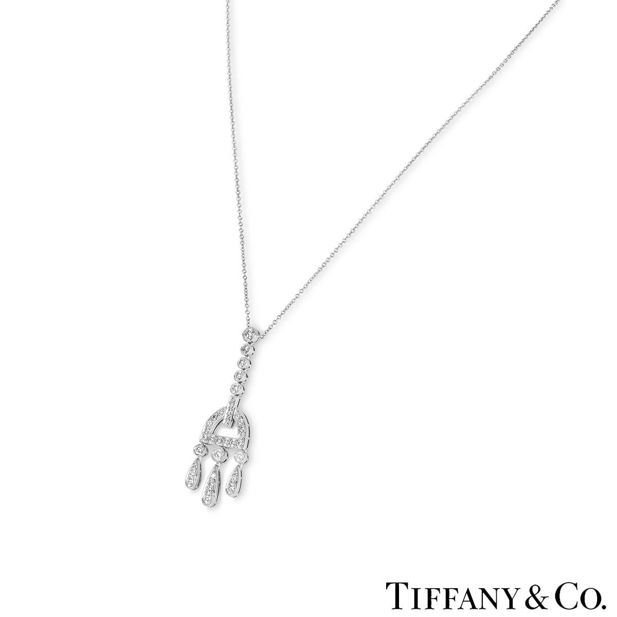 A stunning platinum diamond drop pendant from the Jazz collection by Tiffany & Co. The pendant has a row of five diamonds connecting to a semi circle with a further three diamonds suspending articulated droplets. The pendant has a total of 36 round