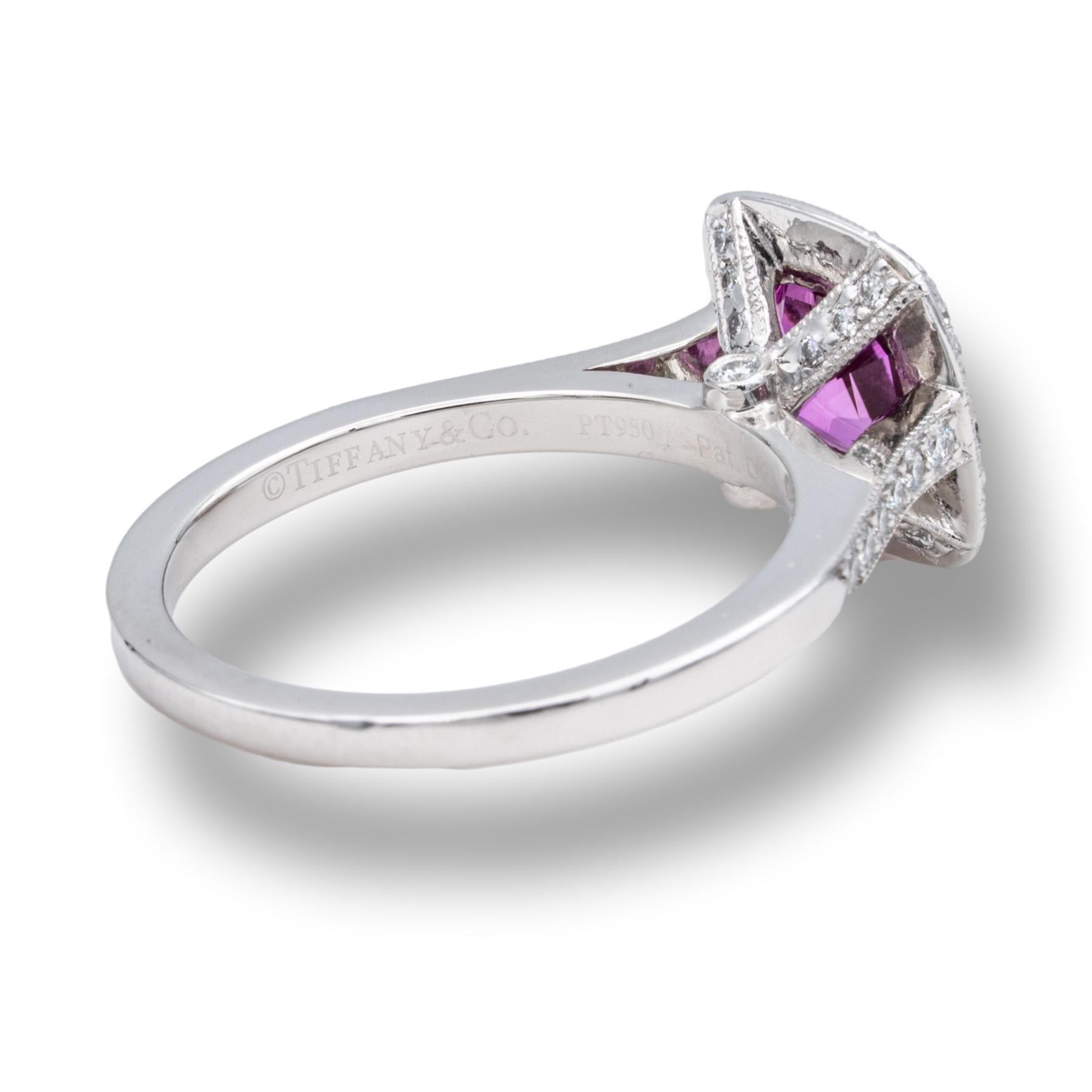 Tiffany & Co Cushion Brilliant Engagement Ring from the “Legacy” collection featuring a 1.51 carat rich color pink sapphire center finely crafted in Platinum surrounded by dazzling bead-set diamonds in a full bezel millgrain design halo and half-way