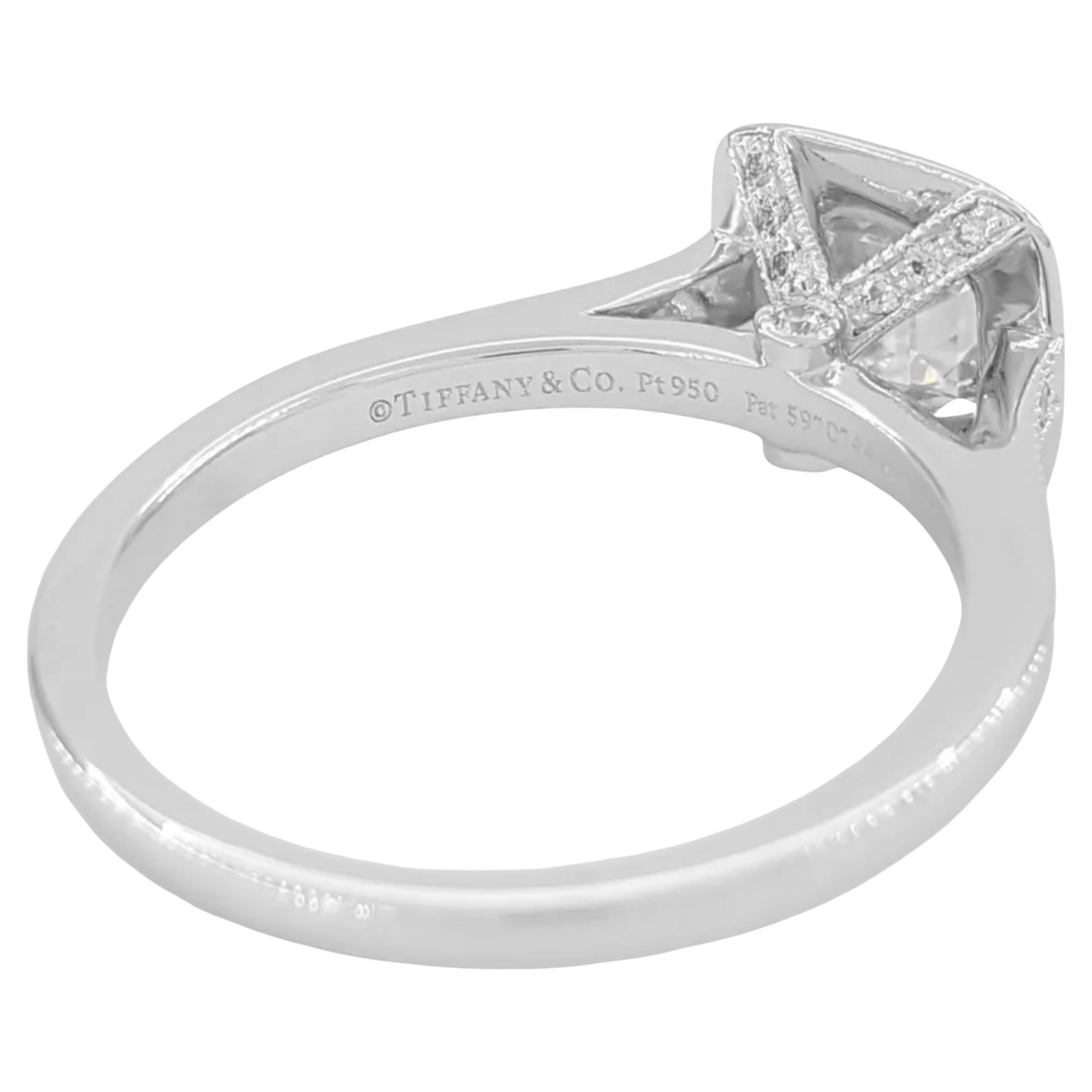 Tiffany & Co. Platinum Legacy engagement ring showcases a stunning 1.05 ct Legacy Cushion Ideal Cut diamond in a halo setting. The ring weighs 5.6 grams and is a size 7.75. The center stone features an F color grade and VS1 clarity, along with