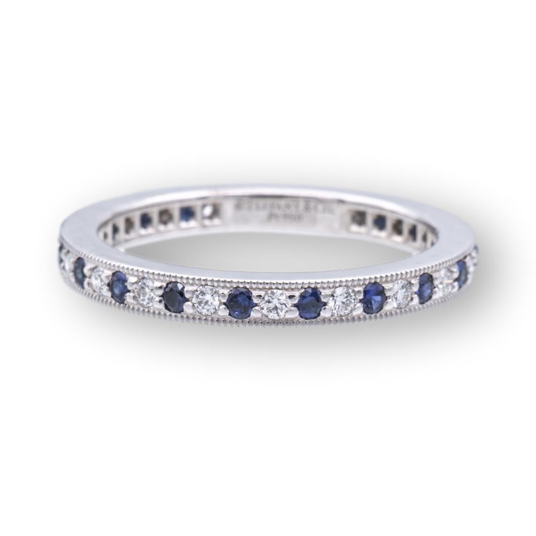 Tiffany & Co. eternity band from the Legacy collection finely crafted in platinum featuring a full circle of interchanging round brilliant blue sapphires and diamonds. The diamonds weigh a total of 0.20 carats and the sapphires 0.26 cts in a channel