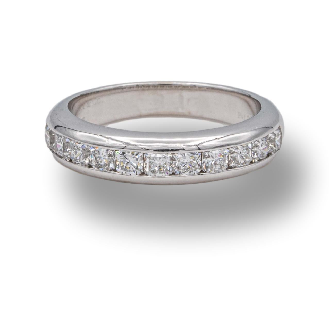 Tiffany & Co. Lucida cut diamond wedding/Anniversary band ring finely crafted in platinum channel set featuring 11 lucida cut diamonds weighing  approximately 0.70 carats in fine quality ranging F-G color, VVS-VS clarity. The band measures