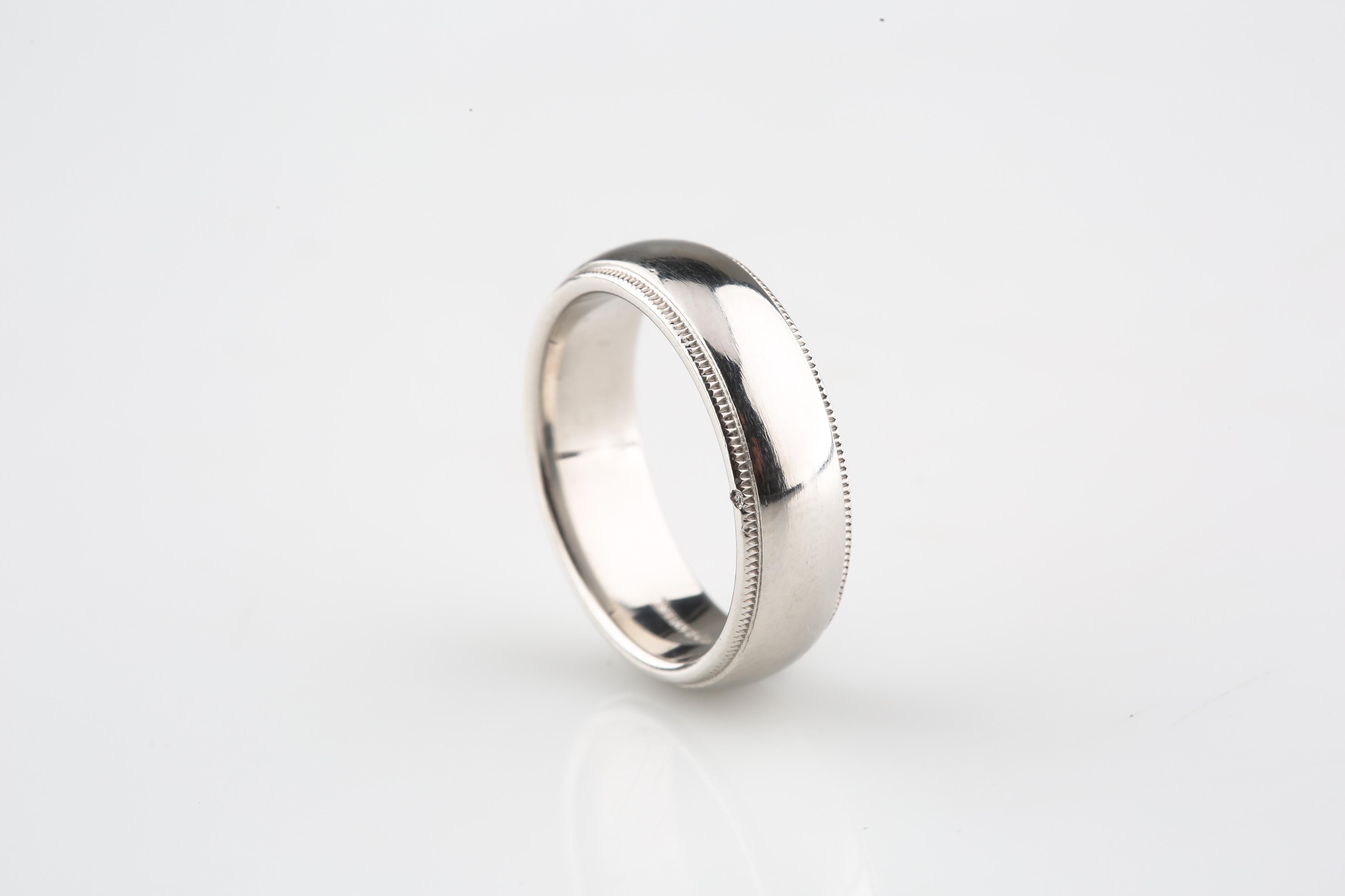 Authentic Tiffany & Co. wedding band, 6mm
Design: milgrain 
Metal: Platinum
Hallmarks: 