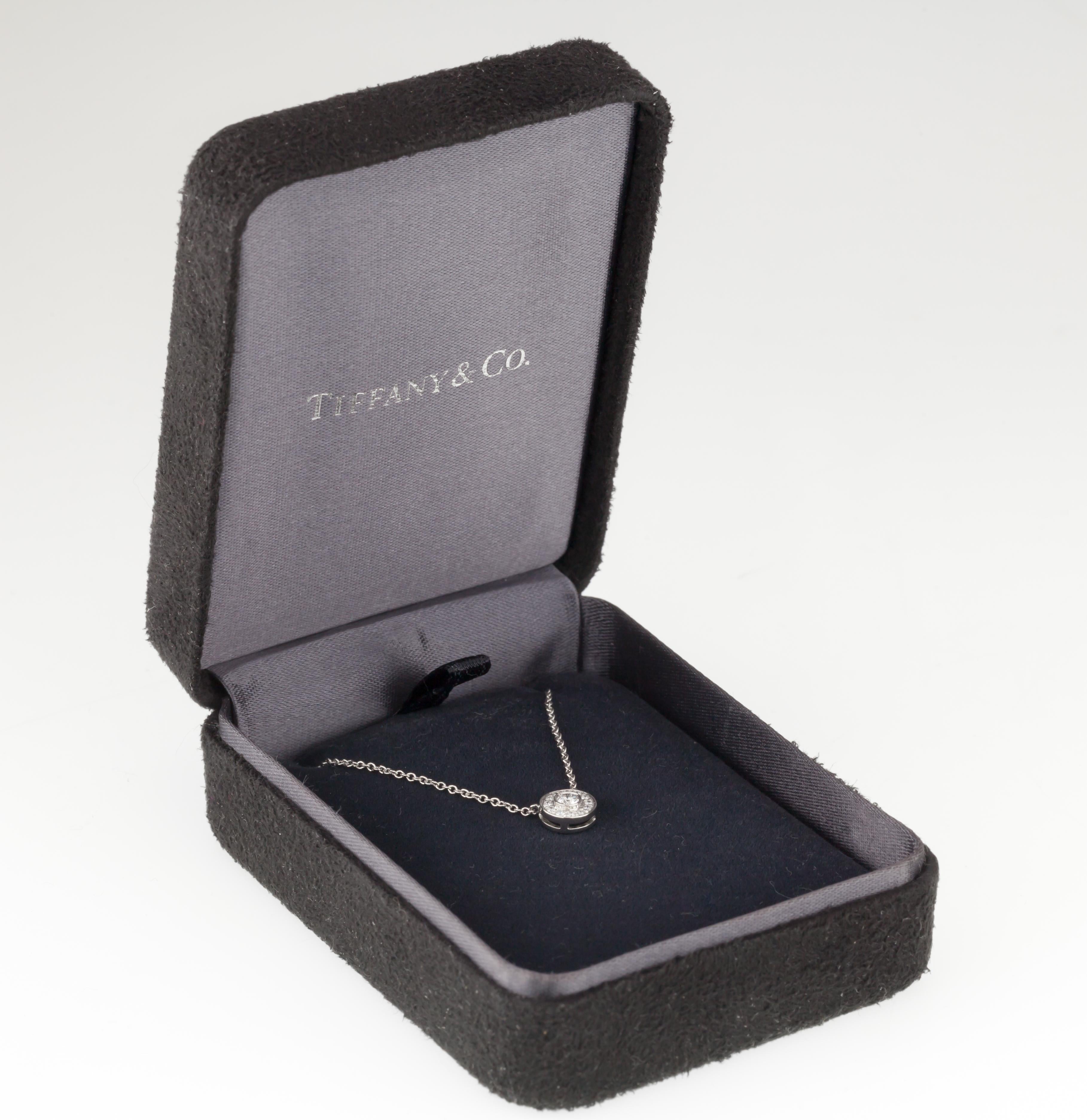 Gorgeous Tiffany & Co. Platinum Diamond Pendant
Features Round Diamond with 12 Smaller Round Diamonds in Bezel
Diameter of Pendant = Appx 7 mm
Total Mass = 2.7 grams
Total Diamond Weight = 0.12 ct
Retail Value = $1700
A Great Deal!