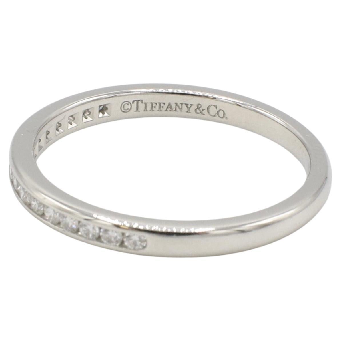 Tiffany & Co. Platinum Natural Diamond Channel Set Band Wedding Ring 
Metal: Platinum
Weight: 3.4 grams
Diamonds: Approx. .17 CTW round natural diamonds F-G VS
Width: 2.3mm
Size: 7 (US)
Signed: ©Tiffany & Co. PT950
Retail: $2,375 (2014)


