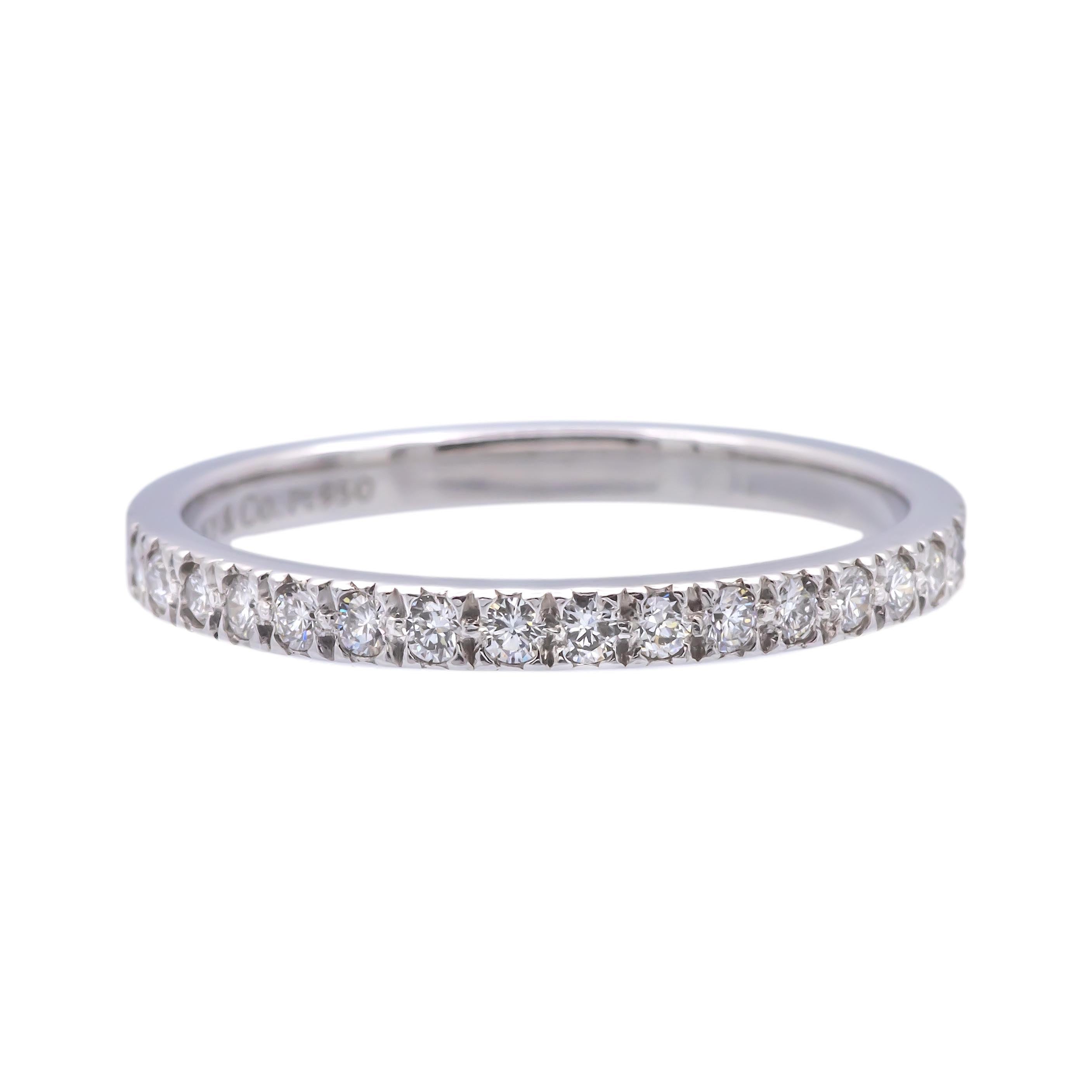 Tiffany & Co. Band ring from the Novo collection finely crafted in platinum featuring 16 round brilliant cut diamonds weighing 0.18 carats total weight approximately encrusted in bead setting going halfway around. Fully hallmarked with logo and