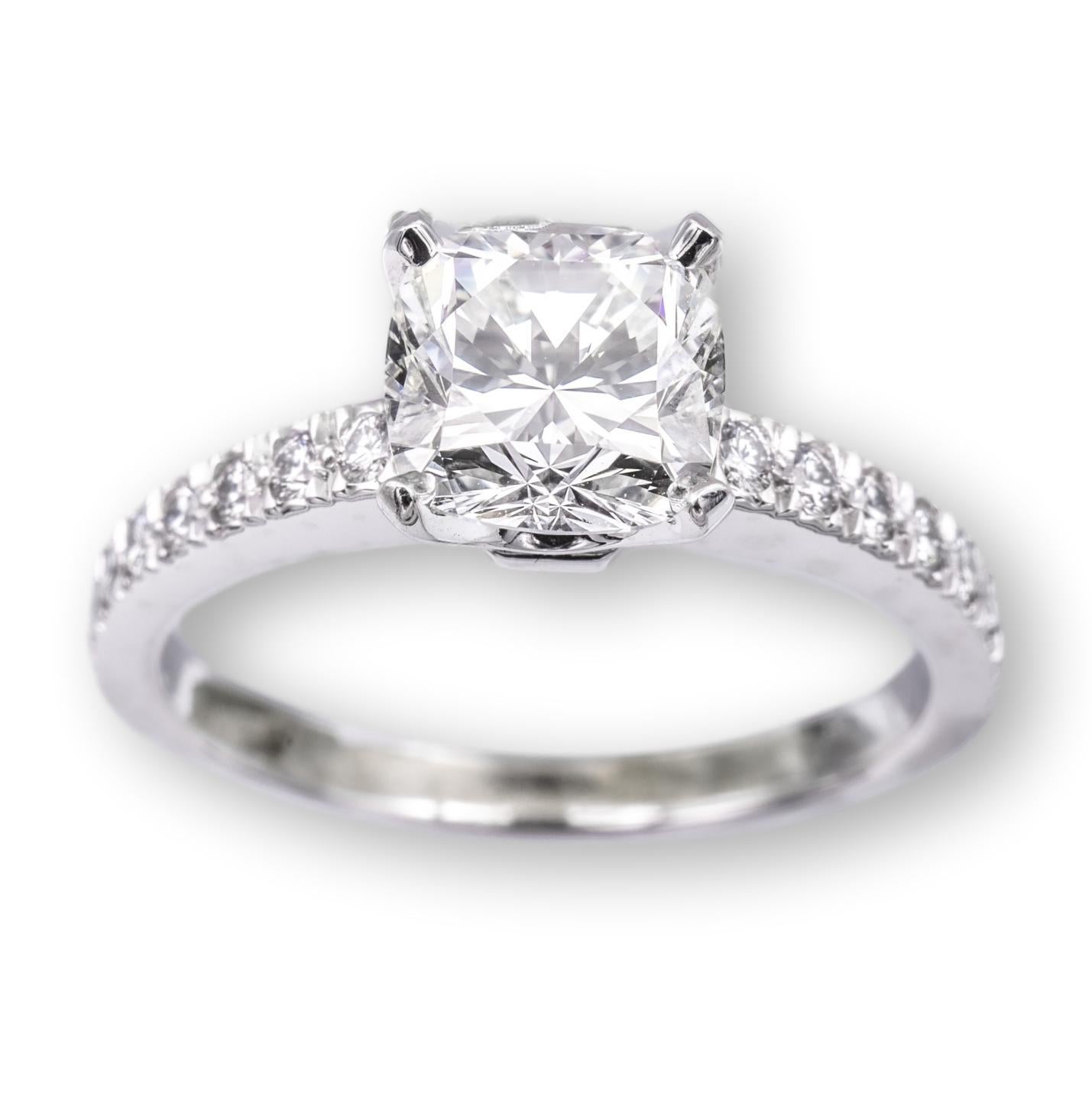 Tiffany & Co. engagement ring from the Novo collection finely crafted in platinum featuring a square cushion brilliant diamond center weighing 1.15 carats , H color , VVS2 clarity set in a 4 prong basket setting adorned with 16 bead set round