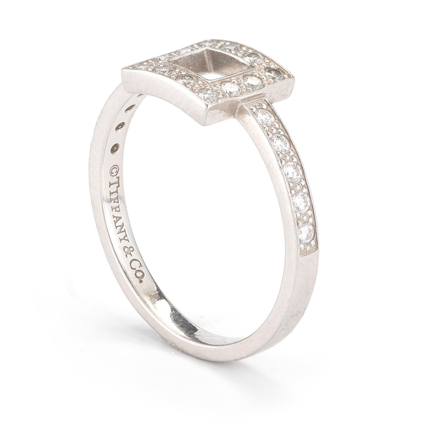 A dainty cutout square motif is accented with round diamonds totaling approximately 0.27ct mounted in platinum, signed Tiffany & Co. Ring size 6. The square motif measures approximately 7.5 x 8mm.