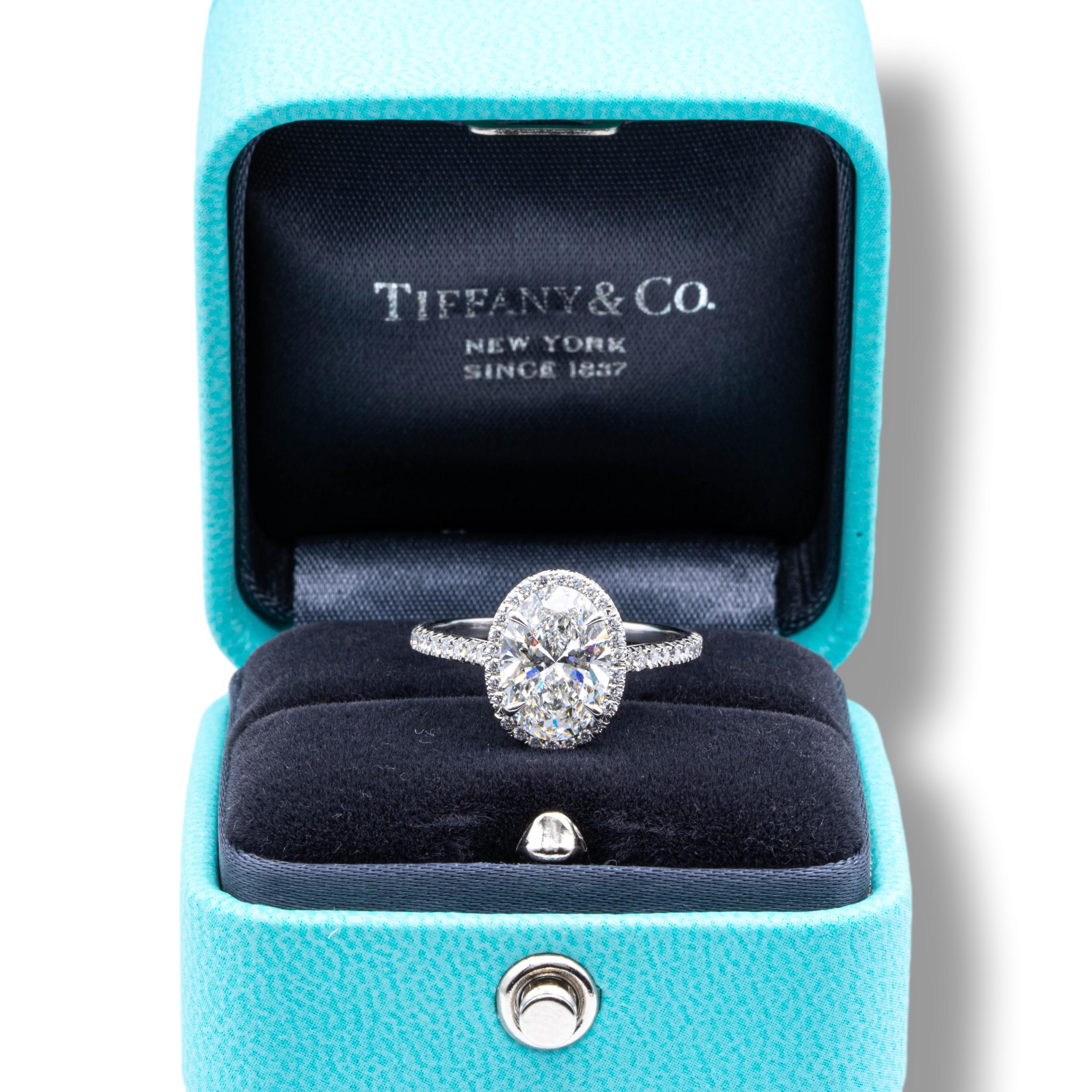 Tiffany & Co. Soleste Diamond Engagement featuring a 2.03 ct Oval Shape Center diamond finely crafted in Platinum graded F color and VS1 clarity with Tiffany certificate #63690147 accented by a bead set diamond halo and shank with 46 round brilliant