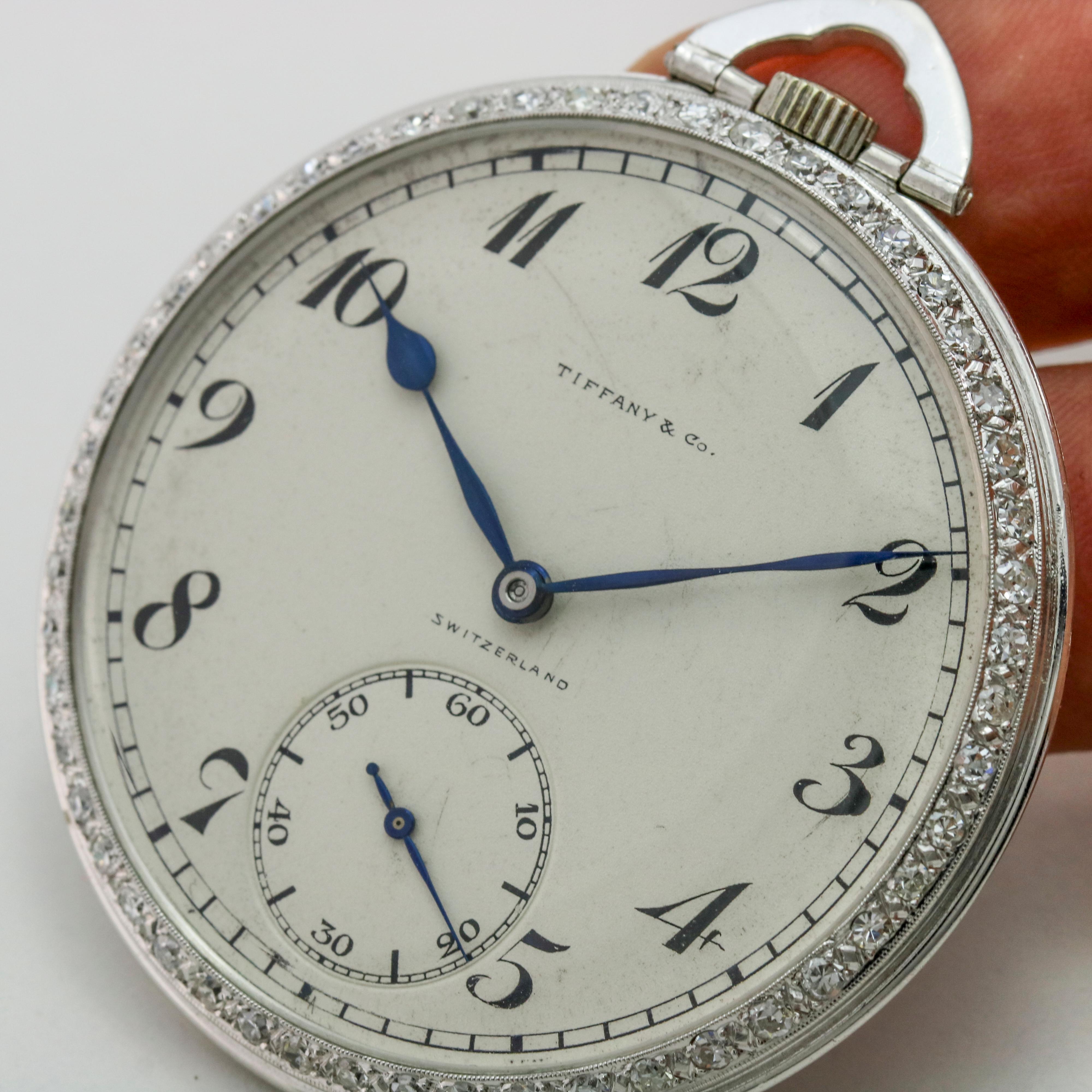 Gent's Tiffany & Co. platinum pocket watch with factory diamond bezel. The watch is powered by a Patek Philippe 18 jewels hand-winding movement. Circa 1930s.

Size, 18
Diameter, 45mm

The watch is in excellent condition and has been serviced by