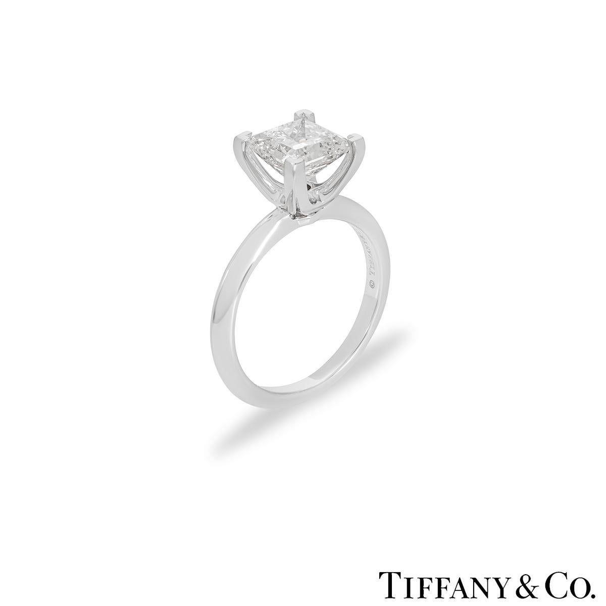 A beautiful platinum diamond ring by Tiffany & Co. The ring comprises of a princess cut diamond in a 4 claw setting with a total weight of 2.04ct, F colour and VS1 clarity. The diamond scores an excellent rating in all three aspects for cut, polish,