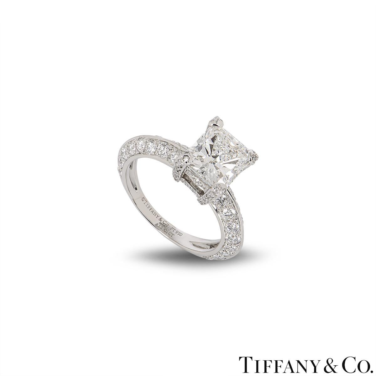 A stunning platinum diamond engagement ring by Tiffany & Co. The ring is set to the centre with a radiant cut diamond in an exquisite four claw mounting, weighing 2.01ct, G colour and IF (internally flawless) clarity. The knife edge engagement ring