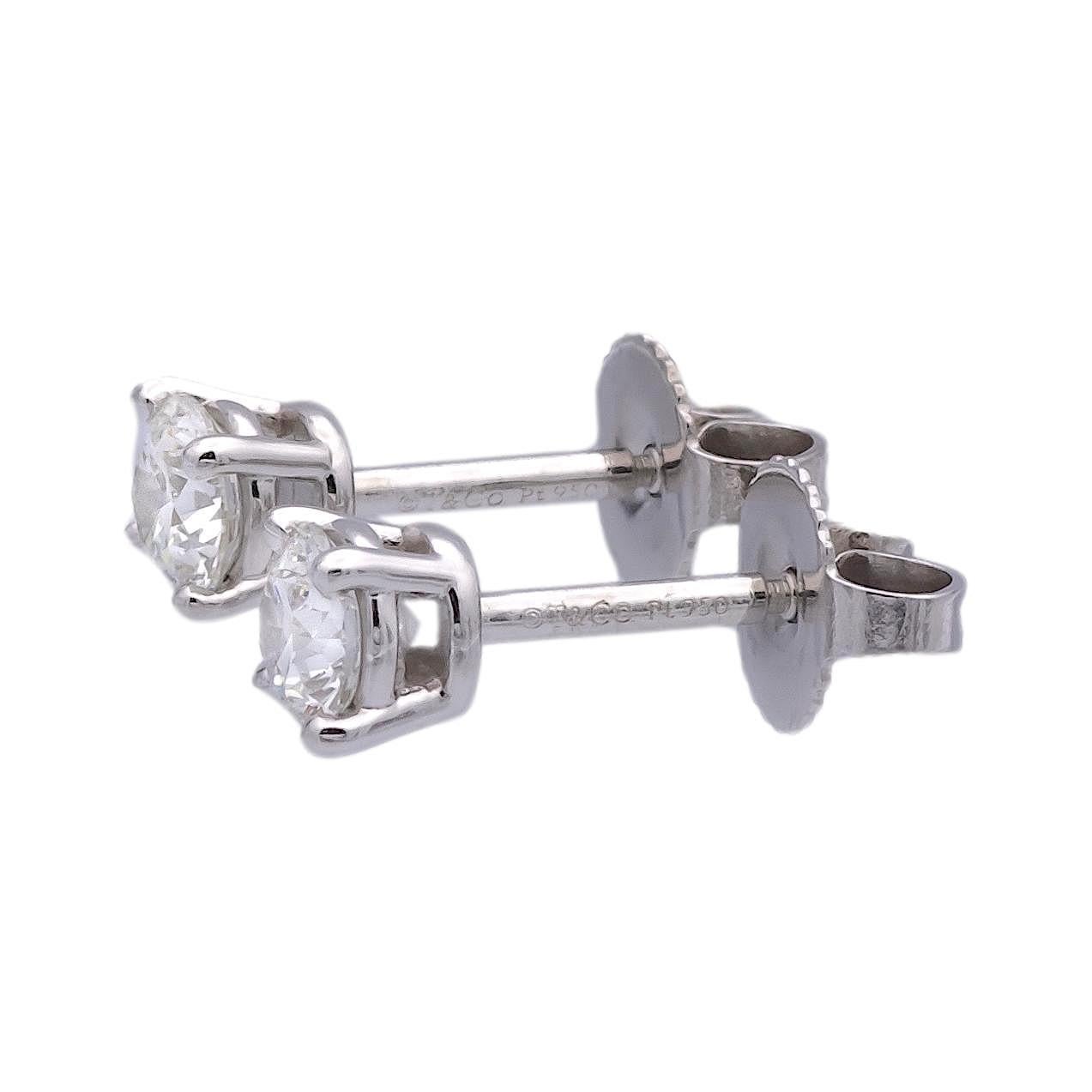 Pair of Tiffany & Co. Diamond Stud earrings finely crafted in a Platinum 4 prong basket setting featuring two perfectly matched round brilliant cut diamonds weighing 0.62 carats total weight. One round brilliant diamond weighs 0.31 carats graded F