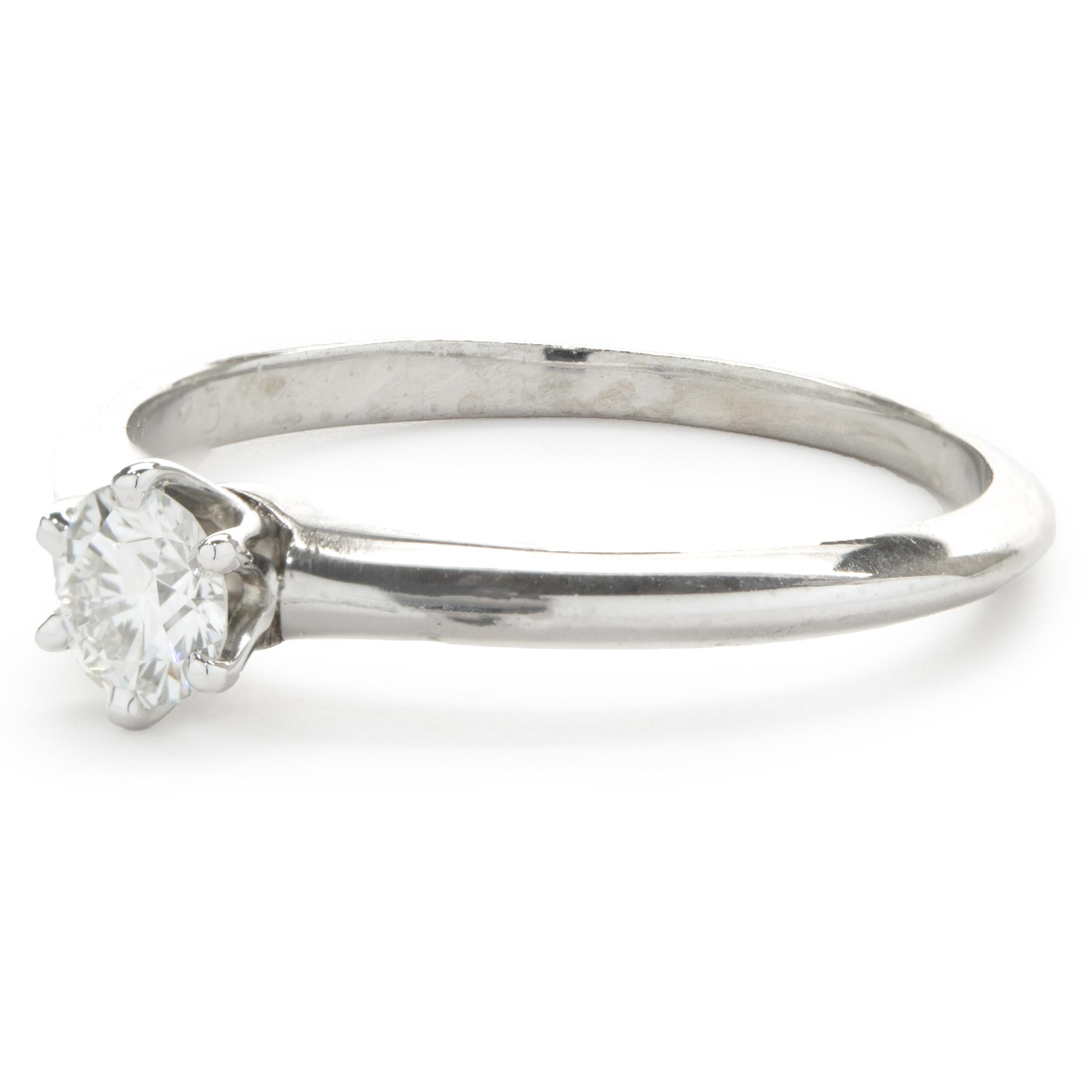 Designer: Tiffany & Co. 
Material: platinum
Diamond: 1 round brilliant cut = 0.23ct
Color: F
Clarity: VS1
Size: 5.5 (complimentary sizing available)
Dimensions: ring top measures 4.80mm wide
Weight: 2.60 grams
