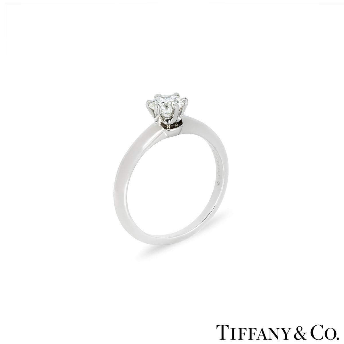 A beautiful platinum diamond solitaire by Tiffany & Co. from the Setting collection. The engagement ring is set to the centre with a round brilliant cut diamond in a classic 6 claw mount, weighing 0.56ct, H colour and VVS1 clarity. The knife edge