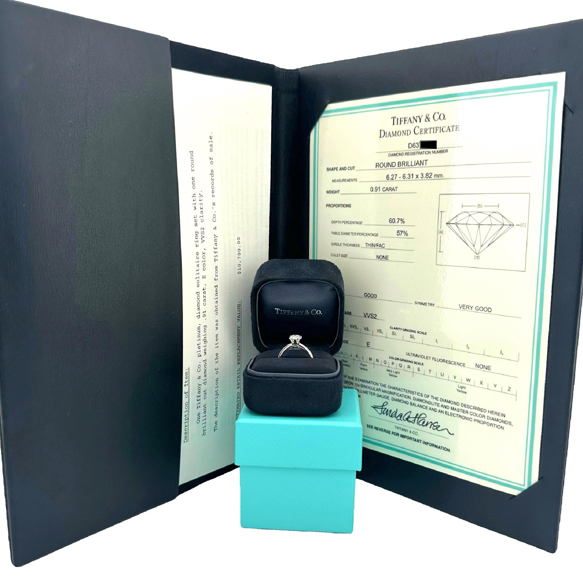 Tiffany & Co Solitaire Diamond Engagement Ring
Style:  Classic Tiffany Setting Prong Set Solitaire
Metal:  Platinum Pt950
Size:  4.25 sizable
Main Diamond:  Round Brilliant Diamond 0.91 cts 
Color & Clarity:  E, VVS2
Diamond Registration Number: 