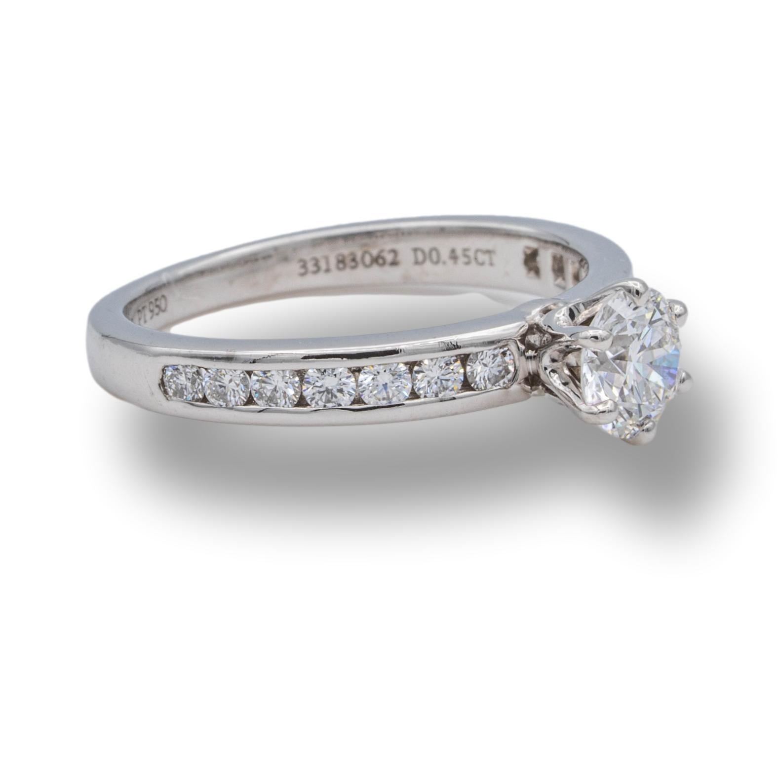 Tiffany & Co. Diamond Engagement ring with channel set diamond band featuring a 0.45 ct center F VS2 finely crafted in 18 platinum. Center diamond is flanked by 7 channel set round brilliant cut diamonds on each side for a total of 14 diamonds