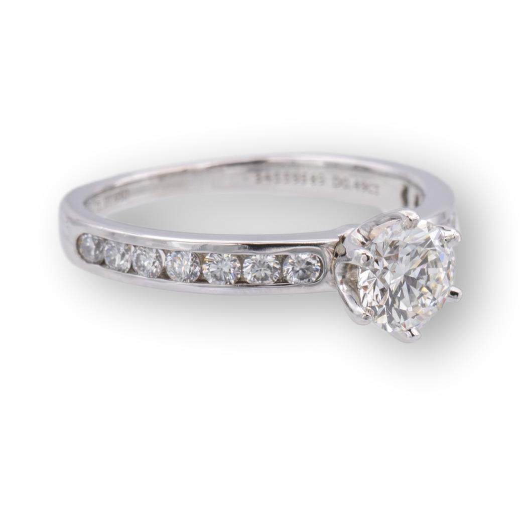 Tiffany & Co. Diamond Engagement ring with channel set diamond band featuring a 0.49 ct center I color, very fine IF clarity finely crafted in platinum. Center diamond is flanked by 7 channel set round brilliant cut diamonds on each side for a total