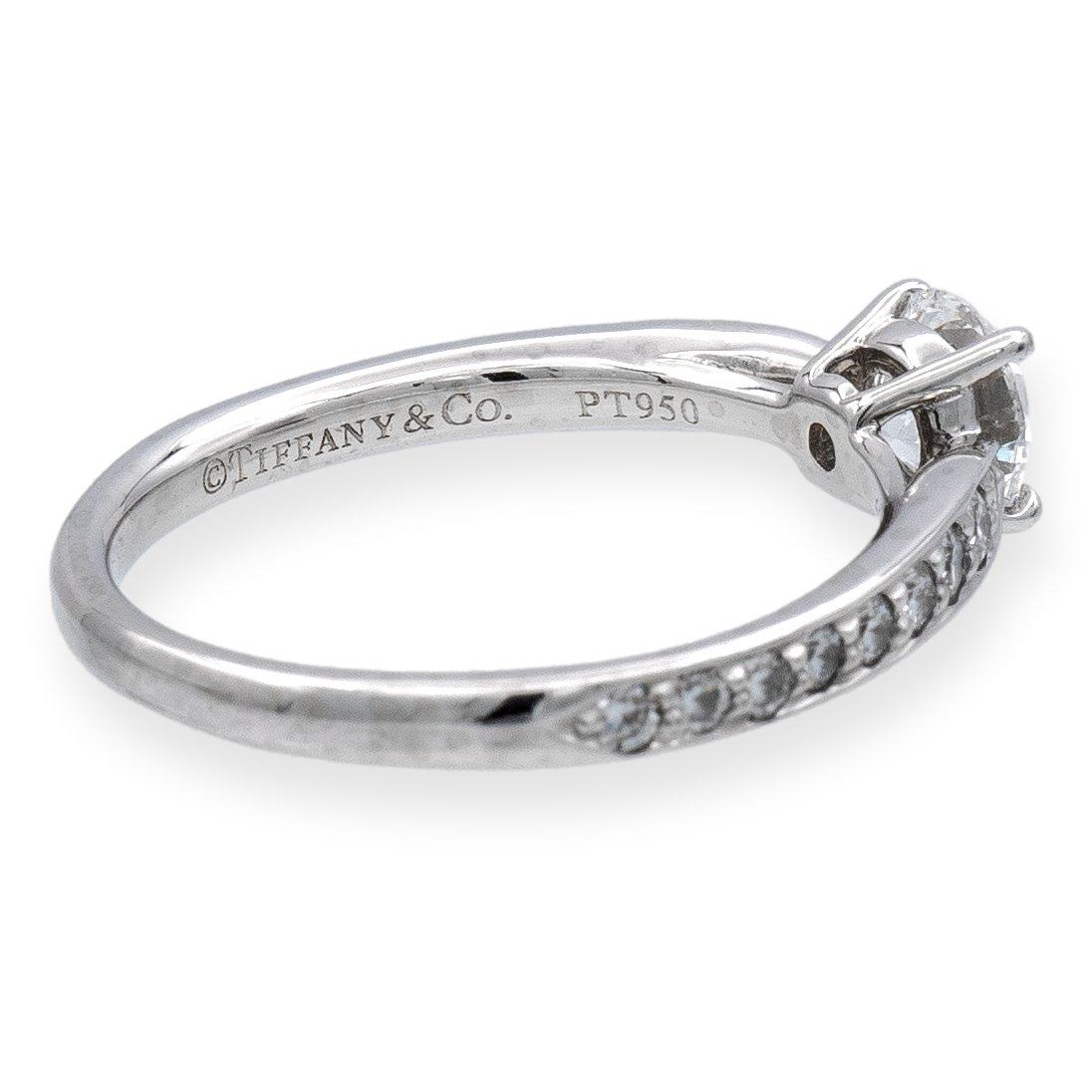 Tiffany & Co. round diamond engagement ring from the Harmony collection finely crafted in platinum featuring a round brilliant cut diamond center  weighing 0.42 carats E color VVS2 clarity. This ring has a tapered shank design. Ring is fully