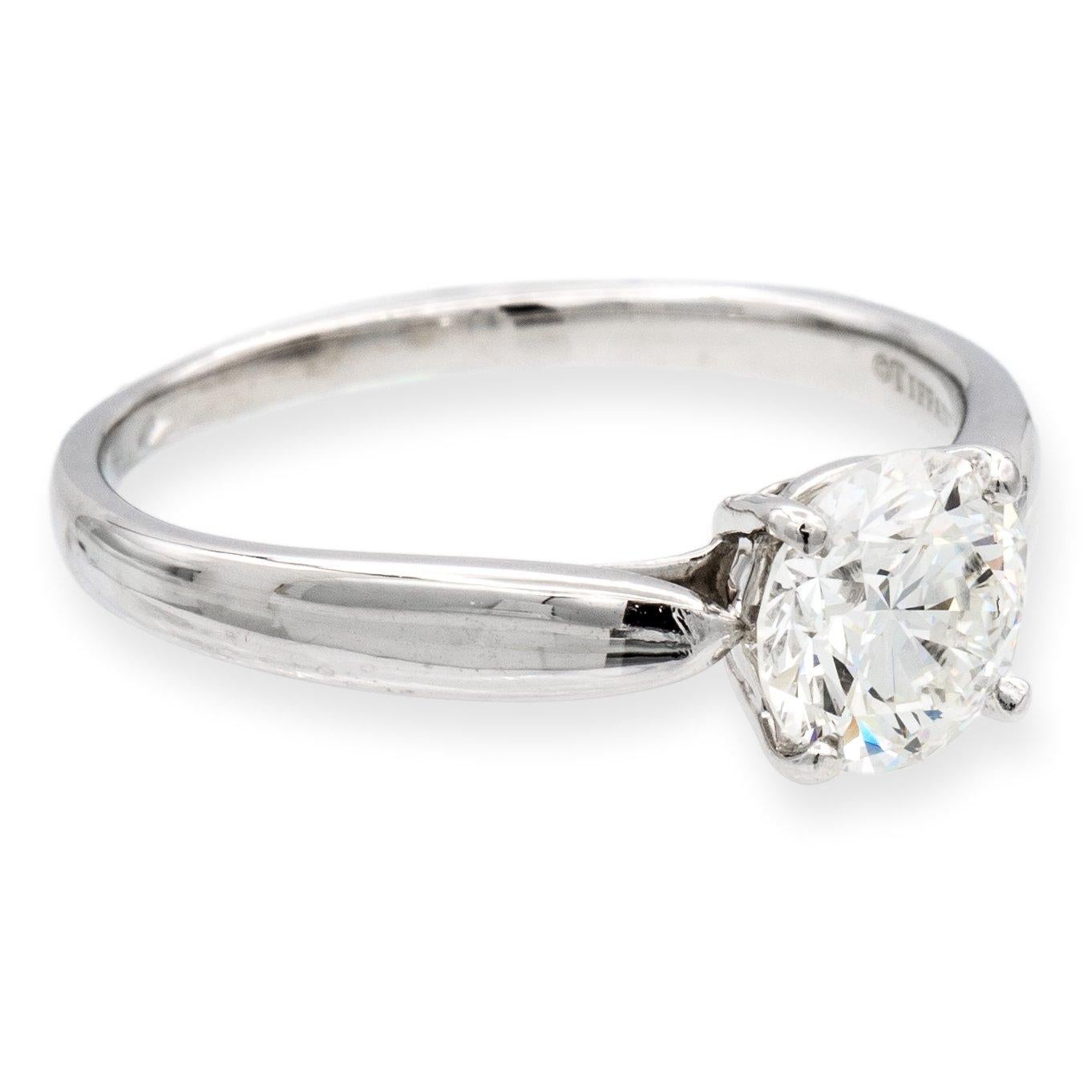 Tiffany & Co. round diamond engagement ring from the Harmony collection finely crafted in platinum featuring a round brilliant cut diamond center  weighing 1.15 carats I color VS2 clarity. This ring has a tapered shank design. Ring is fully
