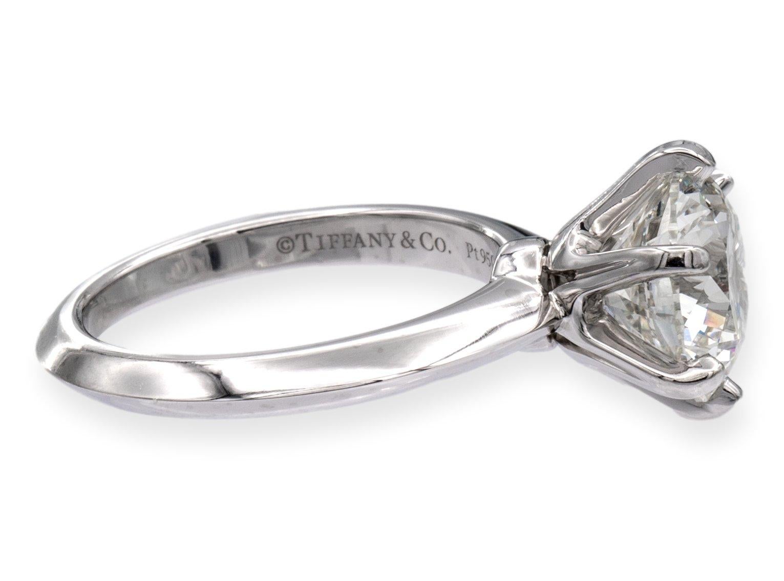 Tiffany & Co Platinum Solitaire Engagement Ring is a timeless and elegant piece that symbolizes love and commitment. The ring is finely crafted with a six-prong platinum mounting, showcasing the 3.24-carat round brilliant cut diamond at the center.