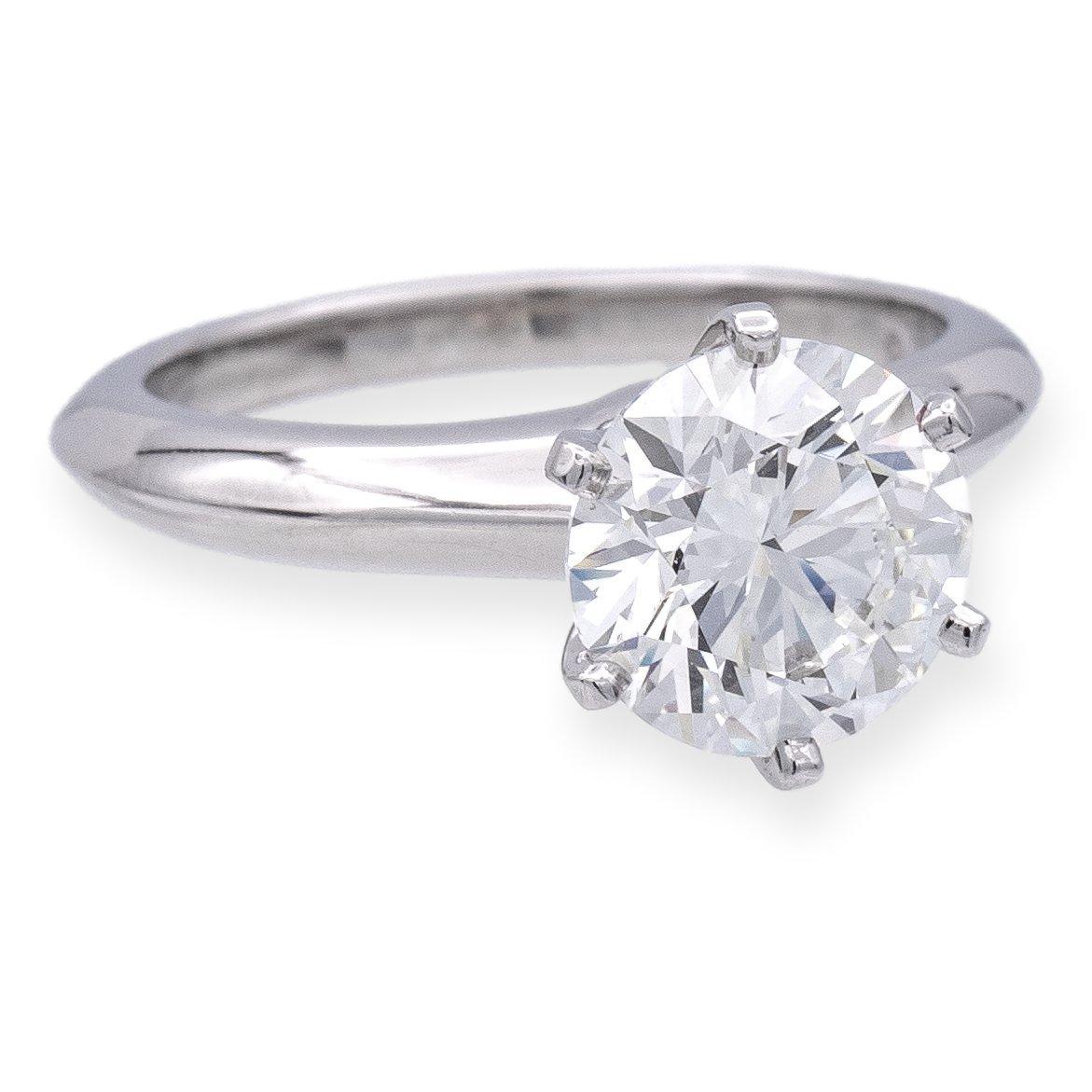 Tiffany & Co. Diamond Engagement ring. Meticulously crafted in a six-prong platinum setting, this exquisite piece showcases a brilliant 2.06 carat center diamond. Graced with an I color and impeccable VS1 clarity, its radiance is enhanced by its