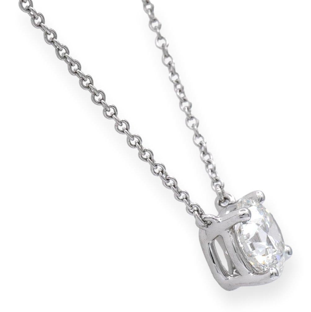 Tiffany & Co. Diamond Solitaire pendant finely crafted in platinum with a round brilliant cut diamond center weighing 1.41 carats G color VVS2 clarity with excellent cut, polish and symmetry. The diamond is set in a 4 prong basket setting hanging