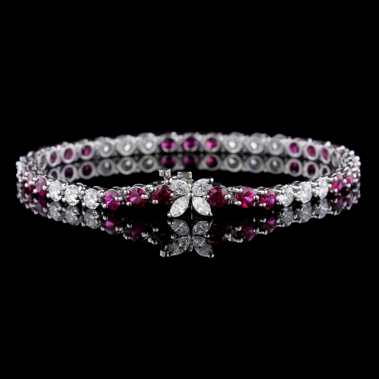 Tiffany & Co. Platinum Ruby and Diamond Victoria Bracelet. The bracelet is set
with 21 round cut rubies, approx. total wt. 4.15cts., 4 marquise cut and 18 full
cut diamonds, approx. total wt. 3.20cts., F color, VS clarity, length 6 3/4, circa 2000,