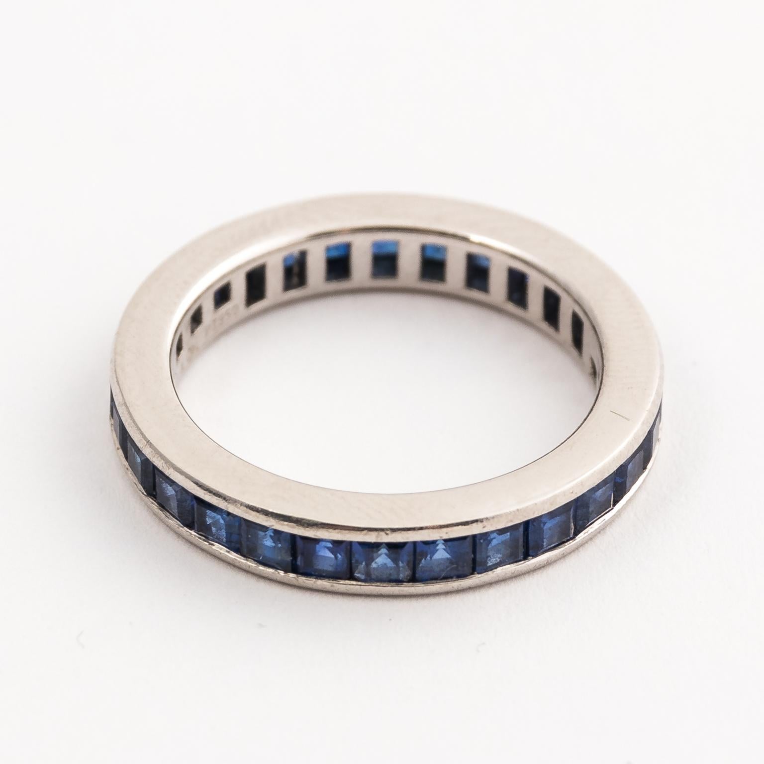 Constructed from solid platinum, the circa 1960's ring has an array of princess cut high quality natural Royal Blue Sapphires invisible set along the platinum band. The Sapphires are carefully selected with matching color, highly transparent, no