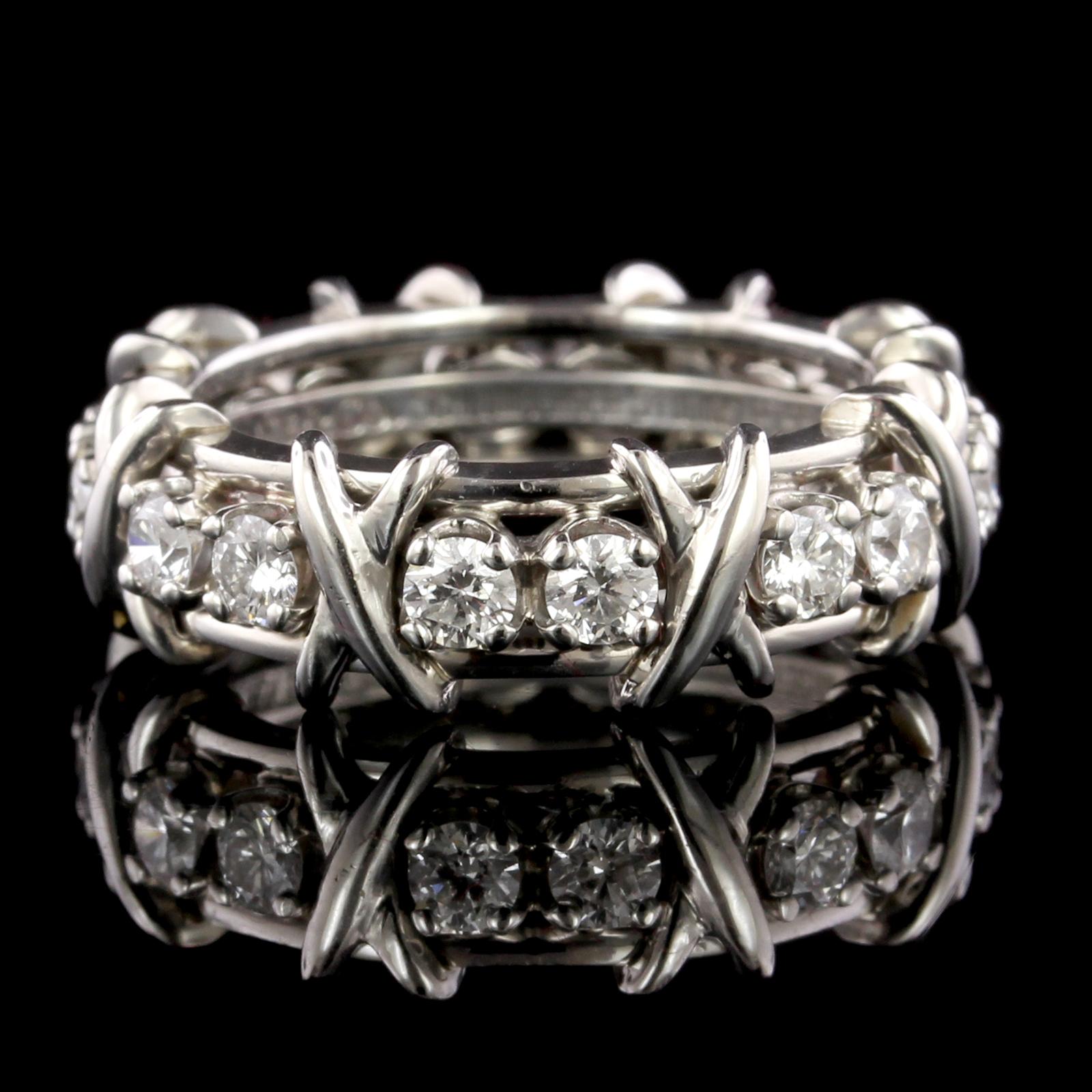 Tiffany & Co. Platinum Schlumberger Band Ring. The band is prong set with 16
round brilliant diamonds, approx. total wt. 1.14cts., F color, VS clarity, size 6 1/4.
 