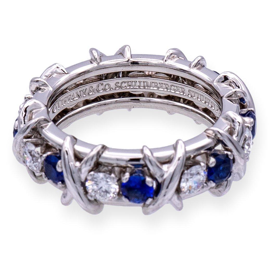 Tiffany & Co. band ring designed by Jean Schlumberger finely crafted Platinum featuring 8 round brilliant cut diamonds weighing .59 carats and round sapphires weighing .75 carats total weight approximately. Fully hallamrked with logo and metal