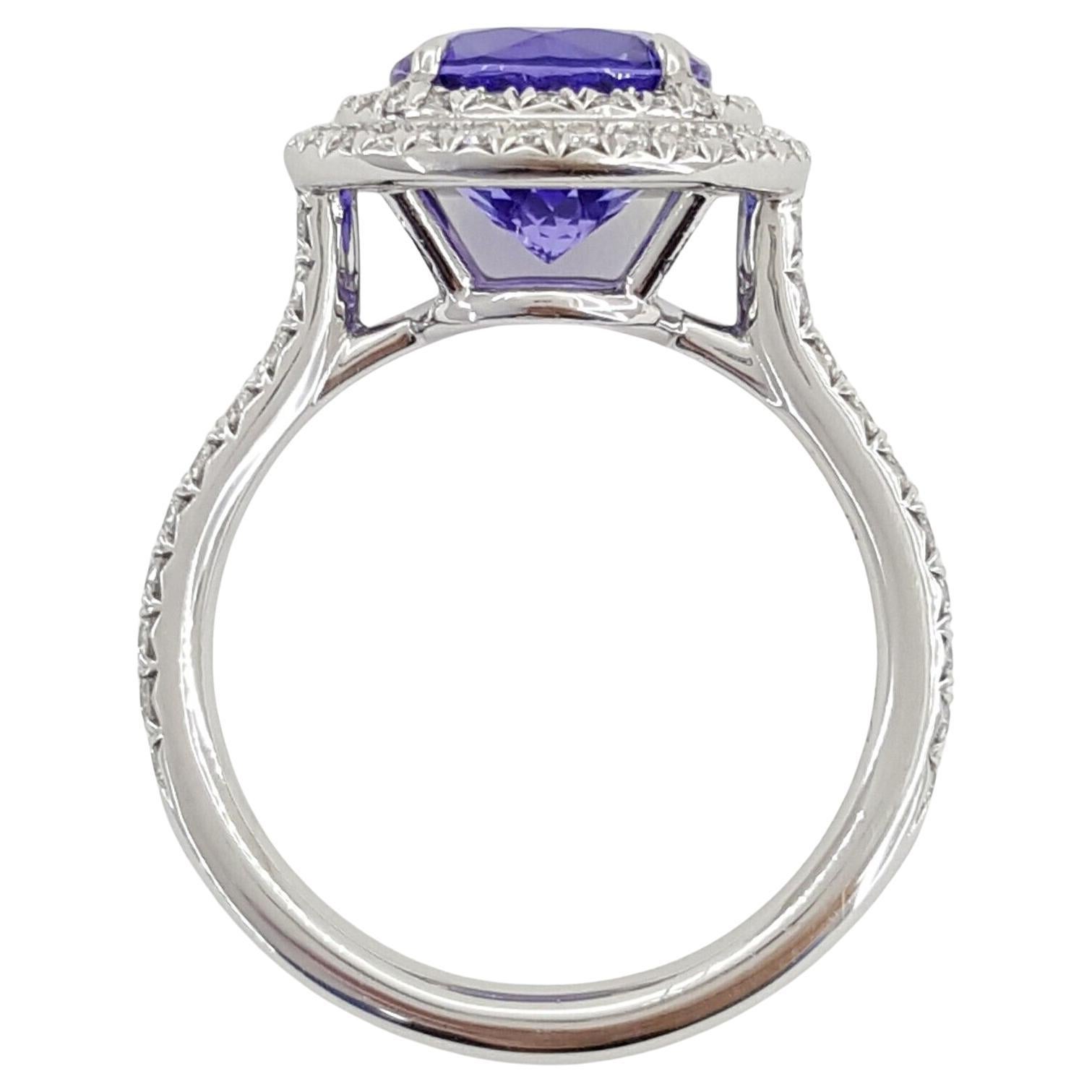 Tiffany & Co. Platinum Soleste® 2.63 ct Round Excellent Cut Diamond Double Halo Engagement Ring.
The ring weighs 6.5 grams, size 6, the center stone is a Natural Round Brilliant Cut Tanzanite weighing approximately 2.15 ct, measuring 8.04 - 8.1 x