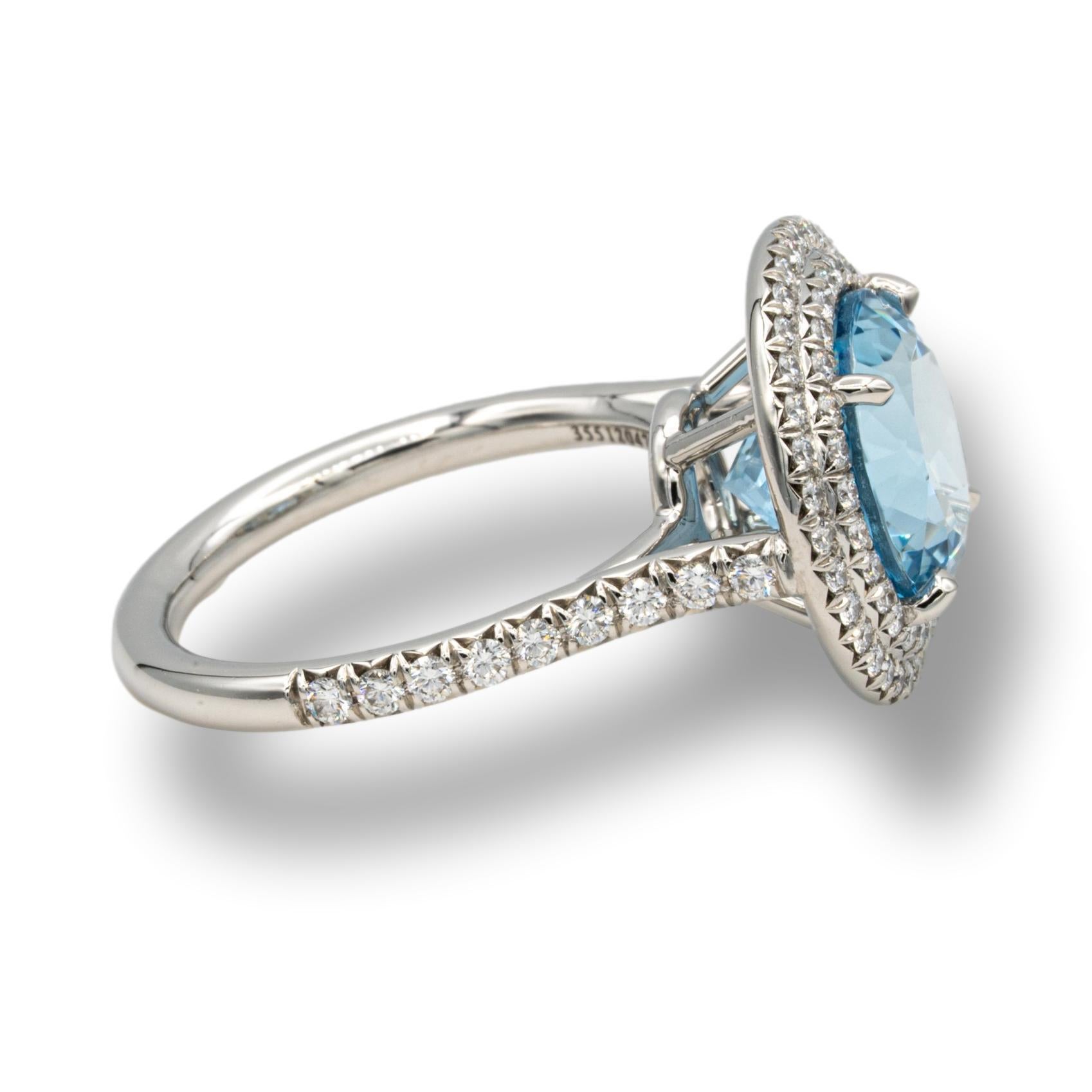 Tiffany & Co. double Soleste aquamarine and diamond ring finely crafted in platinum with a round brilliant cut deep blue color aquamarine weighing 5.00 carats approximately , surrounded by a double row of round brilliant cut bead set diamonds