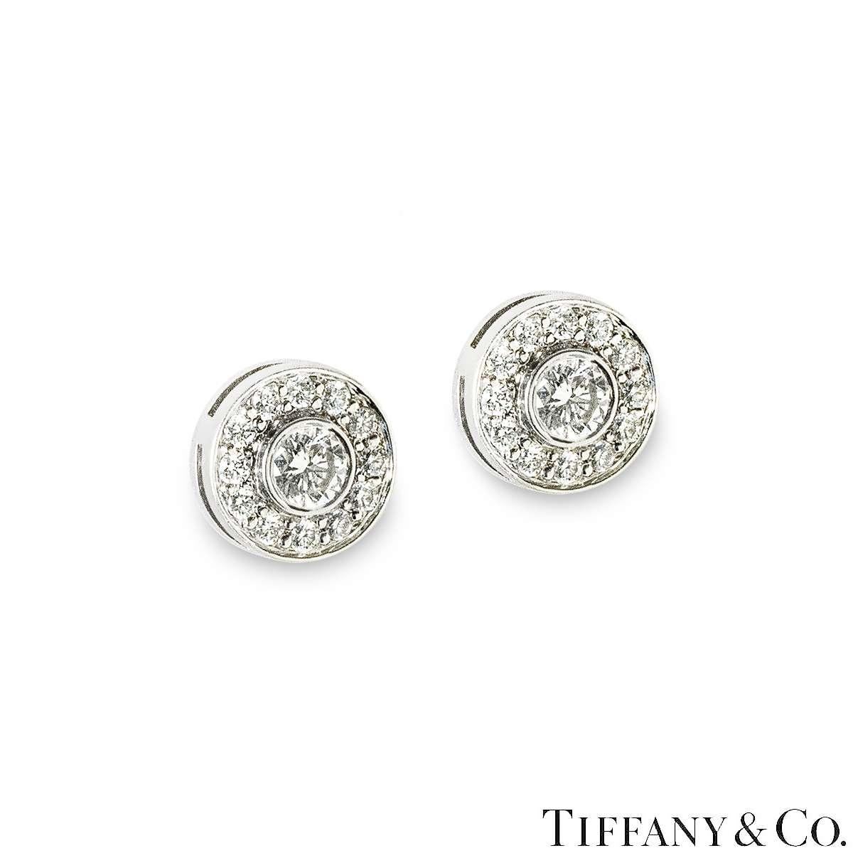 A stunning pair of platinum diamond earrings from the Soleste collection by Tiffany & Co. Each earring is set with a round brilliant cut diamond, complemented by a halo of pave set diamonds. The centre diamonds have a combined diamond weight of