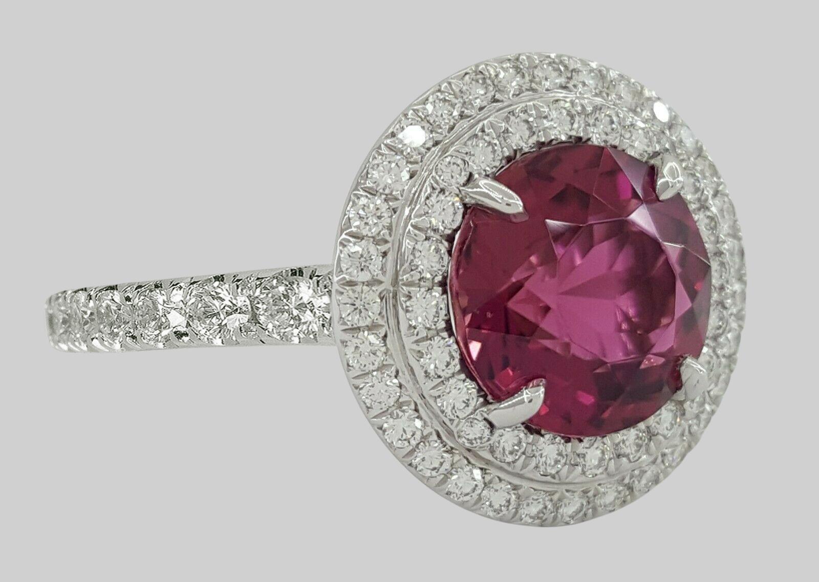  Tiffany & Co. Platinum Soleste® 2.6 ct Pink Tourmaline & Diamond Double Halo Engagement Ring.

The ring weighs 5.9 grams, size 5, the center stone is a Round Brilliant Cut Pink Tourmaline weighing approximately 2 ct, Pink in color, VS1 in clarity,