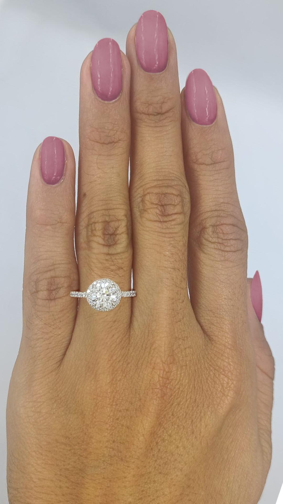Tiffany & Co. Platinum Soleste 1.33 ct Round Ideal Cut Diamond Halo Engagement Ring.

The ring weighs 3.9 grams, size 9, the center stone is a Natural Round Brilliant Cut Diamond weighing 1.10 ct, F in color, VS1 in clarity
