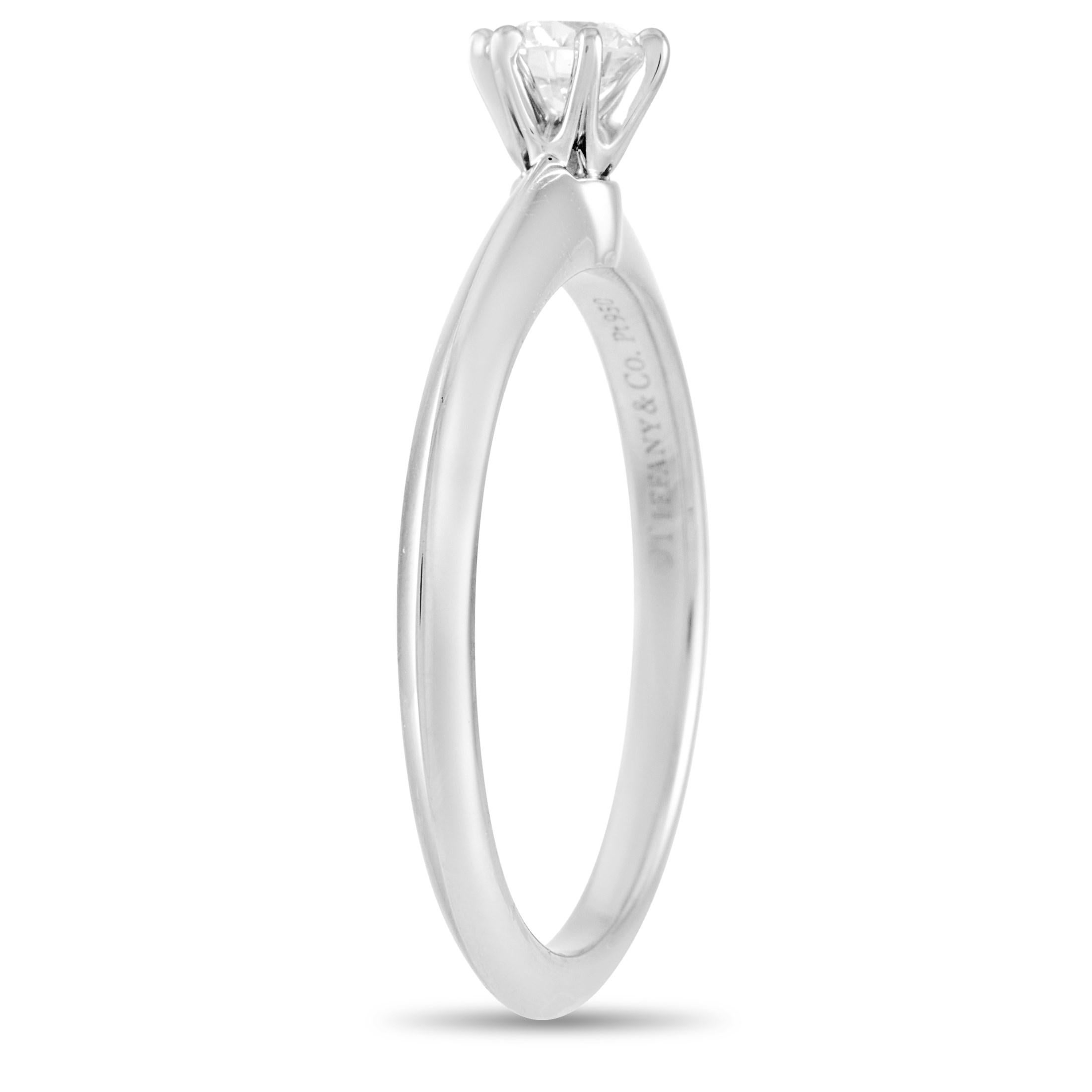 This classic Tiffany & Co. Platinum Solitaire 0.27 ct Diamond Engagement Ring is a timeless piece. The simple band is made with platinum and highlights a single 0.27 carat round-cut diamond of I color and VVS1 clarity. The ring weighs a total of 3.7