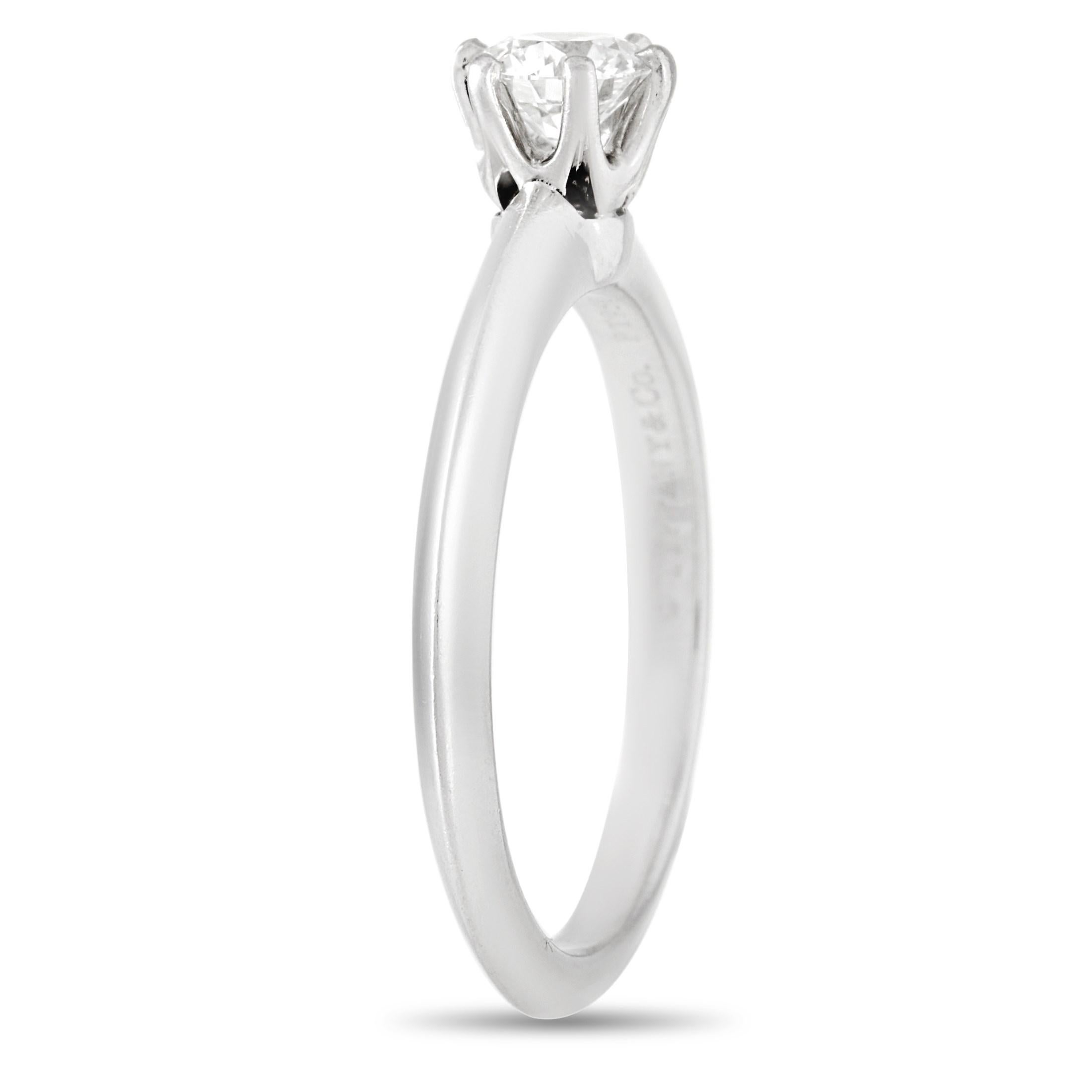 This classic Tiffany & Co. Platinum Solitaire 0.43 ct Diamond Engagement Ring is a timeless piece. The simple band is made with platinum and highlights a solitary 0.43 carat round-cut diamond of H color and VS2 clarity. The ring weighs a total of