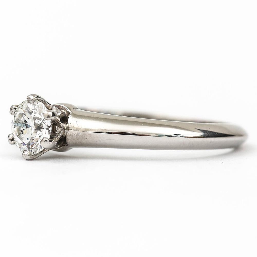 A platinum mounted single stone, round brilliant diamond ring made by Tiffany of New York. The diamond weight is 0.35ct with G colour and VS1 clarity grade made in 2003. This is a classic diamond ring with the added attraction of the Tiffany & Co.