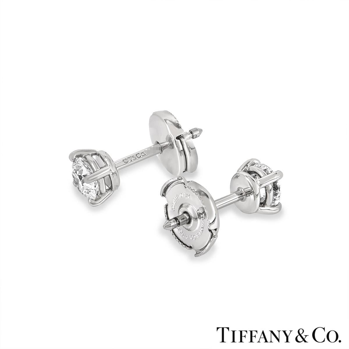 A gorgeous pair of platinum diamond ear studs by Tiffany & Co. Each earring is set with a round brilliant cut diamond in a four-claw setting. Both diamonds have a weight of 0.41ct and are H colour, one diamond is VS1 clarity and the other is VS2