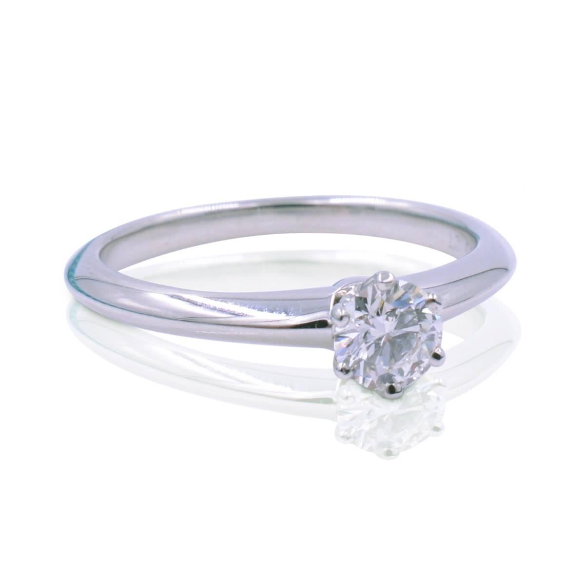 Solitaire six prong diamond engagement ring in Platinum made with round brilliant cut 0.22ct of F color VS2 clarity. Hallmarked Tiffany & Co and is 100% authentic. Ring size 5 and can be adjusted. 