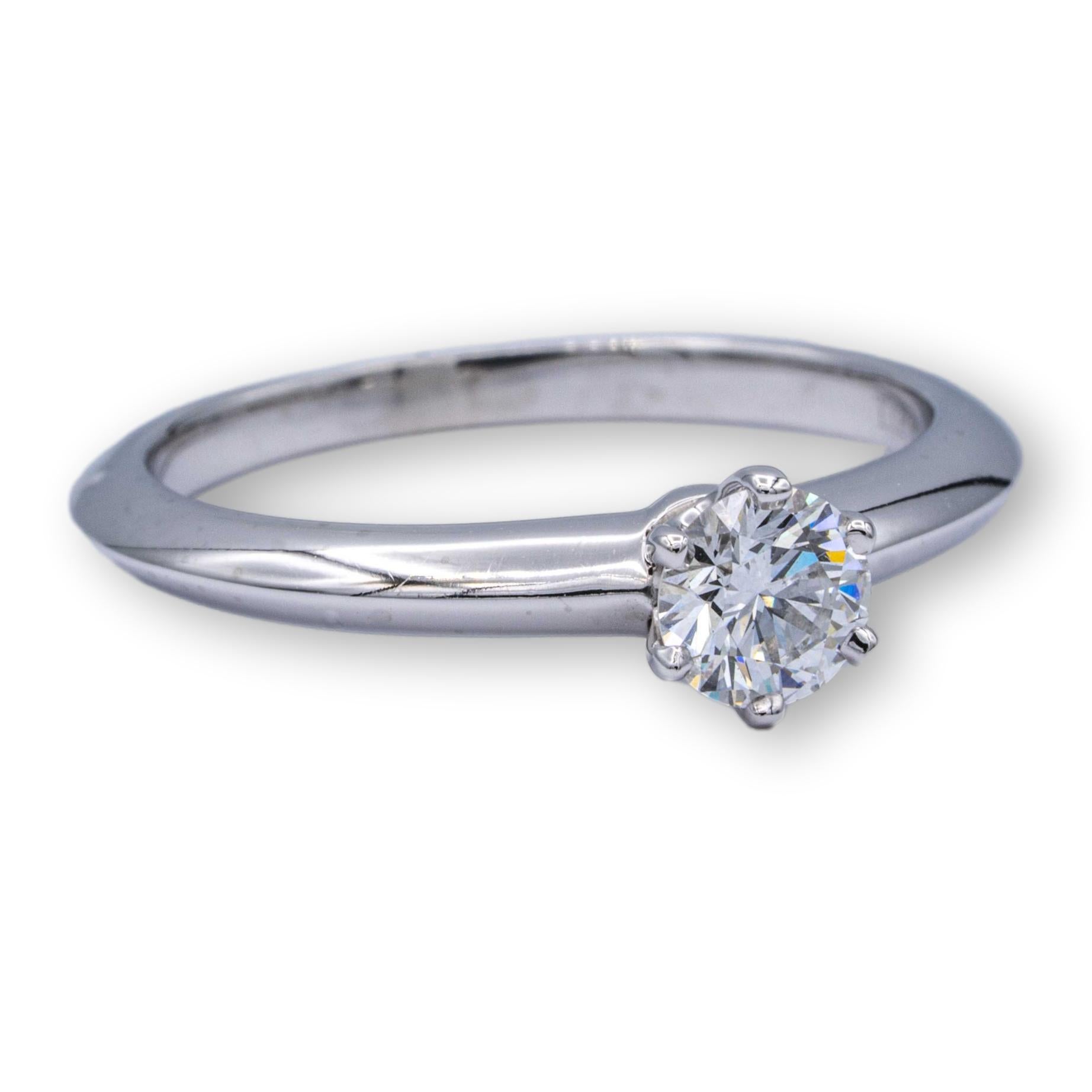Tiffany & Co. Vintage solitaire engagement ring with a round brilliant cut diamond center weighing 0.30 carats F color VS1 clarity. Fully Hallmarked.

Ring Specifications:
Brand; Tiffany & co.
Hallmarks: Tiffany & Co. 17570374 .30 CT
Finger Size: