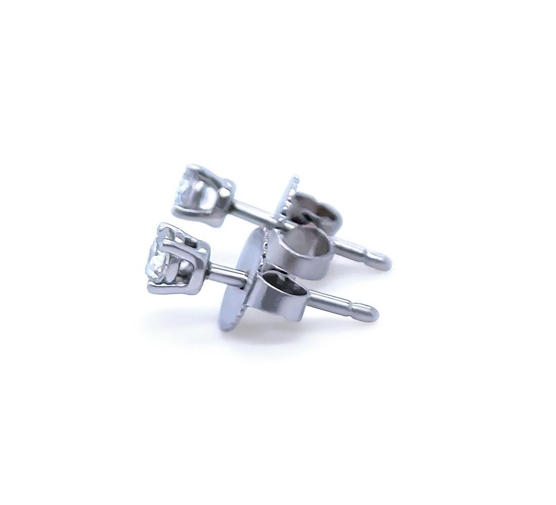 A Pair of Tiffany & Co Solitaire Diamond Stud Earrings, made of 950 Platinum. Earrings set with a total of 2 Round Brilliant Cut Diamonds in a 4 claw setting, each Diamond F Colour, VS Clarity and weighing 0.11ct each, 0.22ct total. Weight 1.3