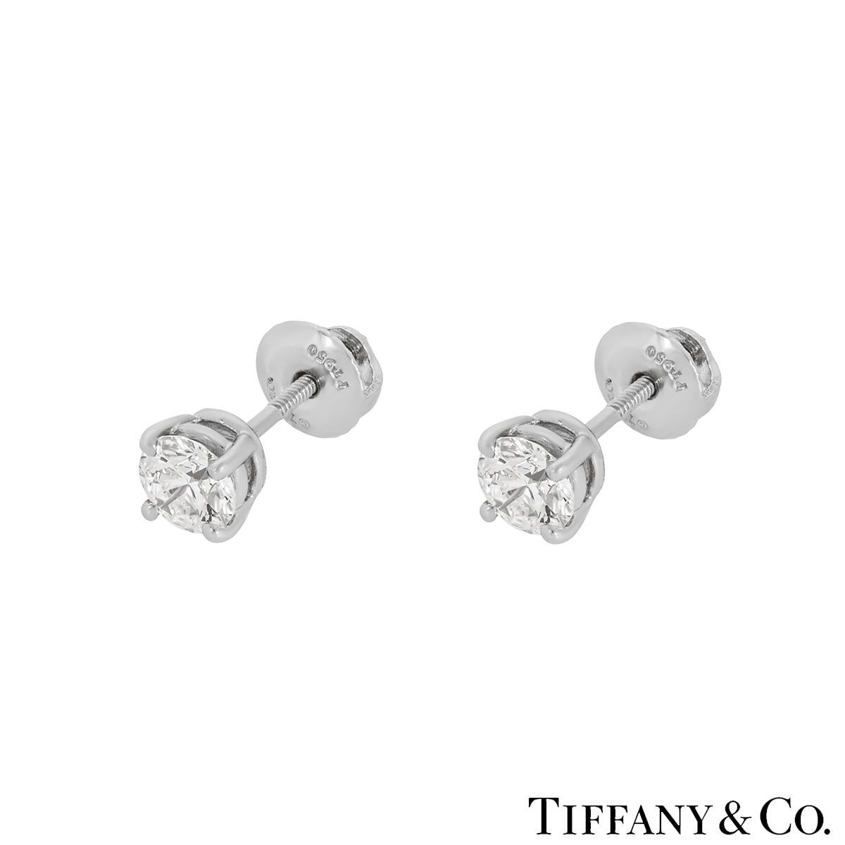 A lovely pair of platinum diamond earrings from Tiffany & Co. The four prong solitaire studs are meticulously matched and have an approximate total weight of 0.80ct, G colour and VS1 clarity. They finish with threaded posts and screw back fittings